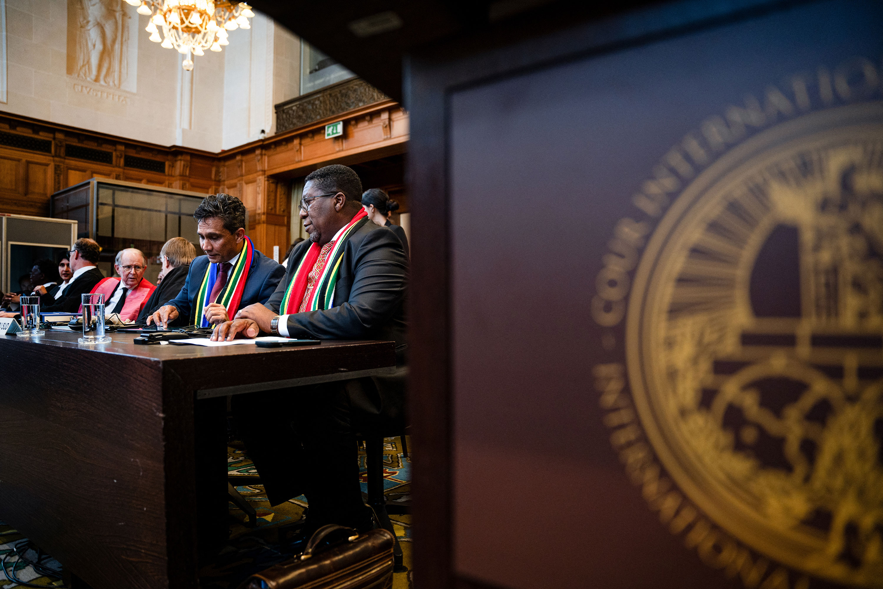 South Africa's Vusimuzi Madonsela, seated right, and Cornelius Scholtz, seated second left, attend a hearing at the International Court of Justice in The Hague, Netherlands, on May 16. 