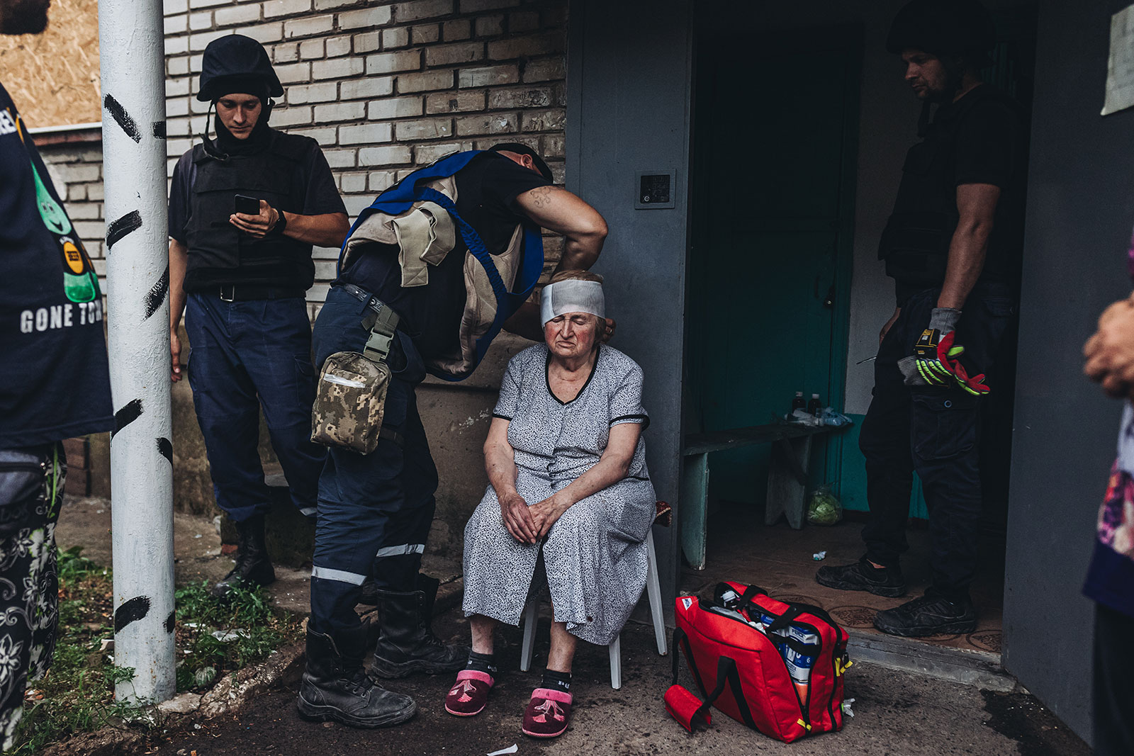 Emergency service workers tend to a woman injured in a shelling in Opytne, Ukraine, on August 1. 