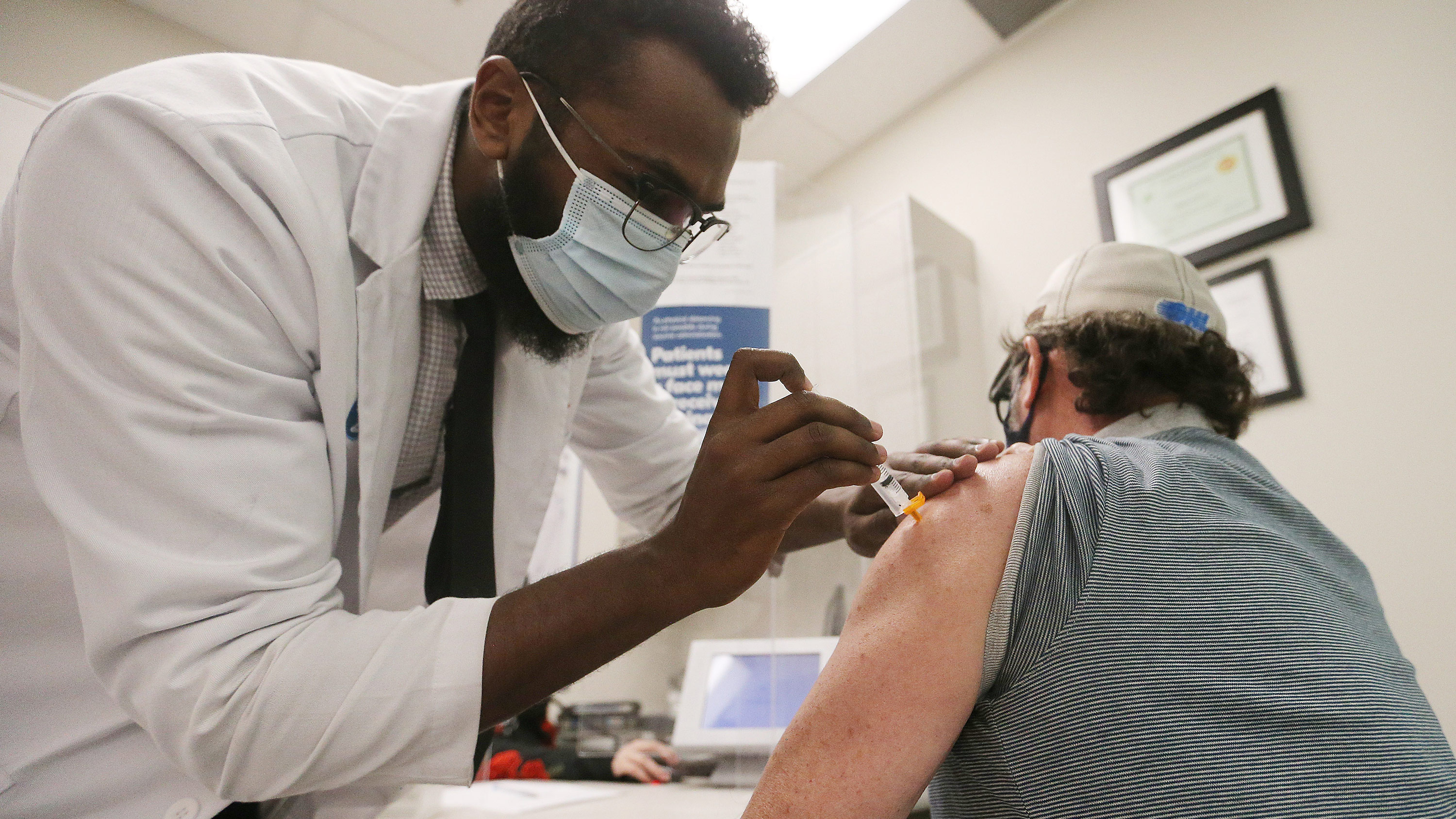 A health worker administers the AstraZeneca Covid-19 vaccine at a Shoppers Drug Mart in Toronto, on March 11. 
