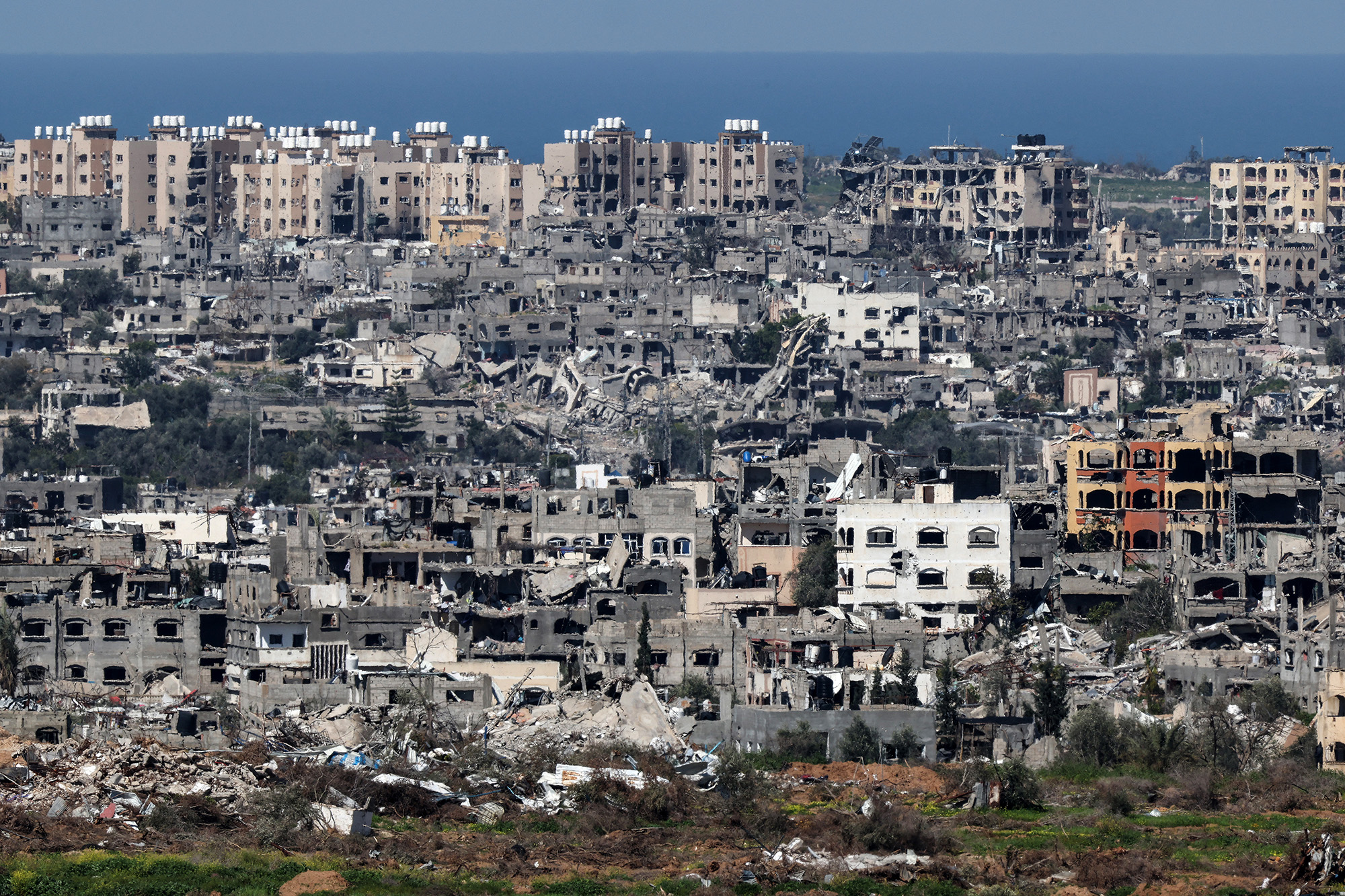 A picture taken from a position in southern Israel on February 29, shows destroyed buildings in the Gaza Strip.