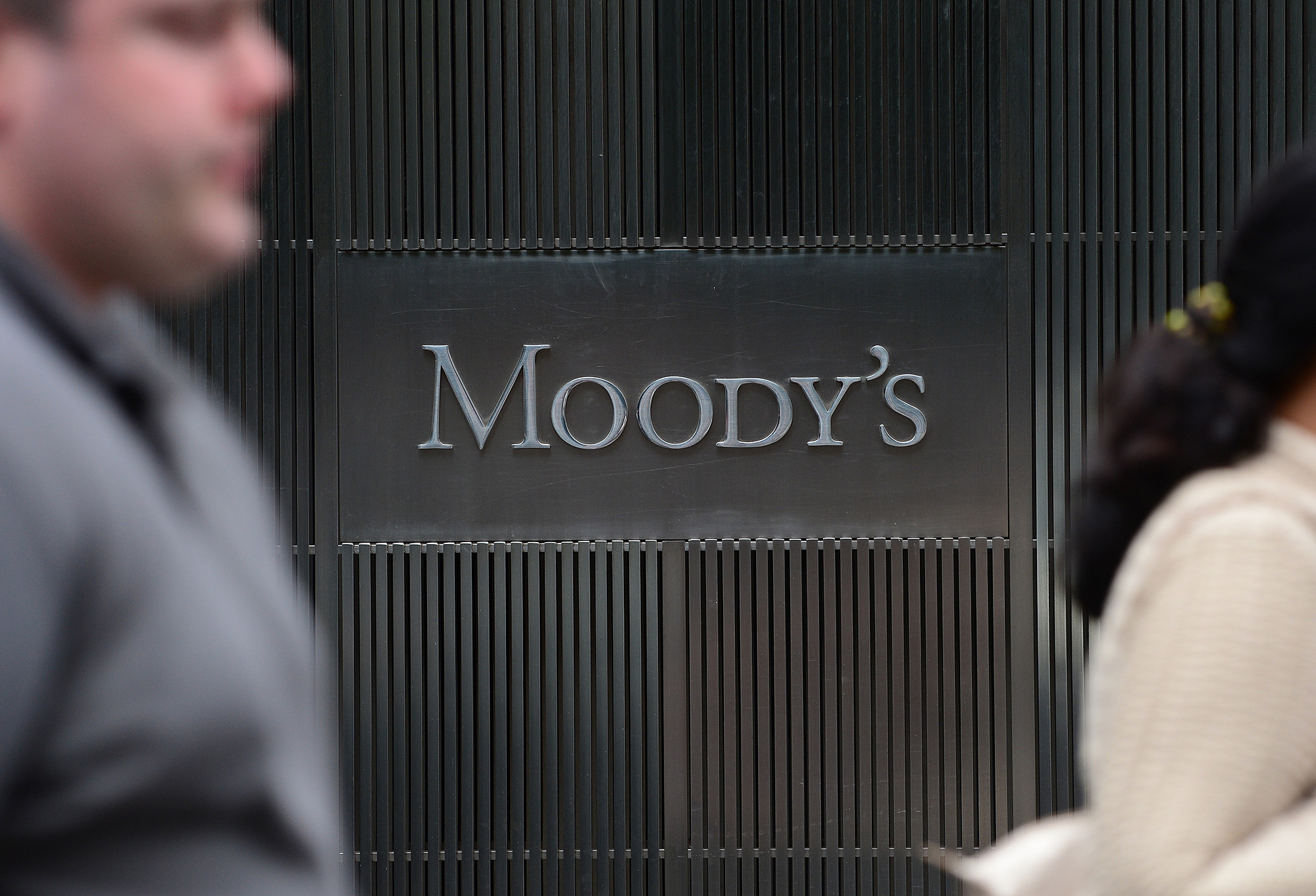 A sign for Moody's rating agency is displayed at the company headquarters in New York, on September 18, 2012.