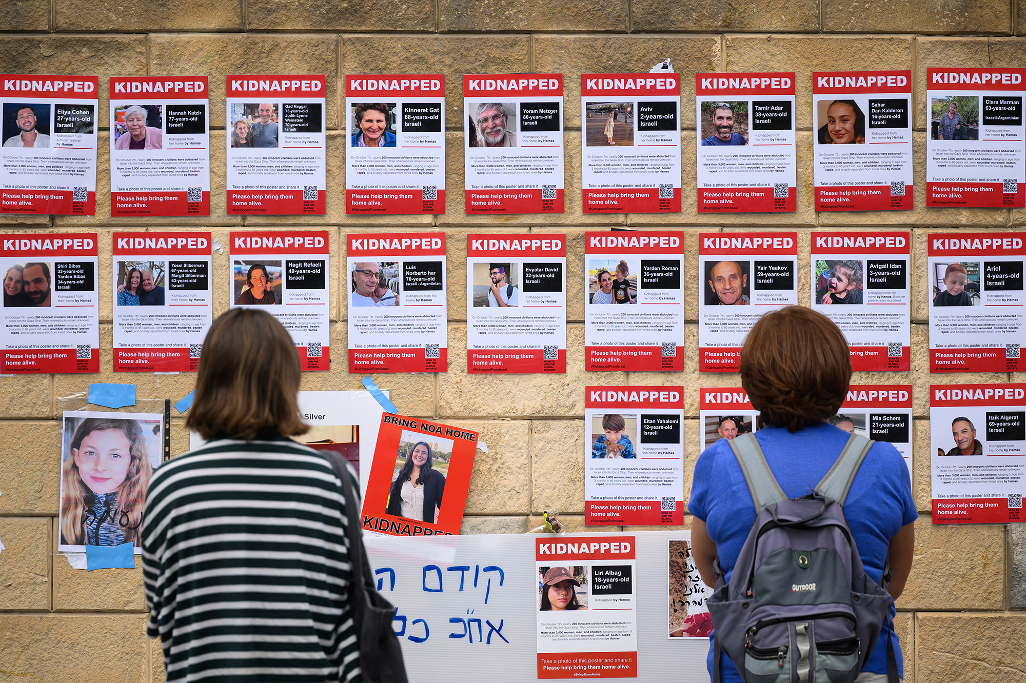 Photographs of some of those taken hostage by Hamas during their recent attacks are seen on October 18, in Tel Aviv, Israel. 