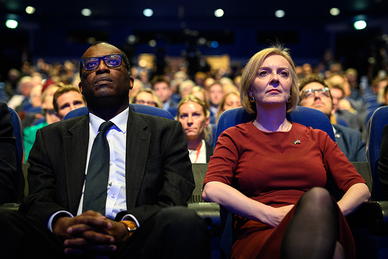 Chancellor of the Exchequer Kwasi Kwarteng (L) and Britain's Prime Minister Liz Truss watch a tribute to Queen Elizabeth II on the opening day of the annual Conservative Party conference on October 2 in Birmingham, England. 