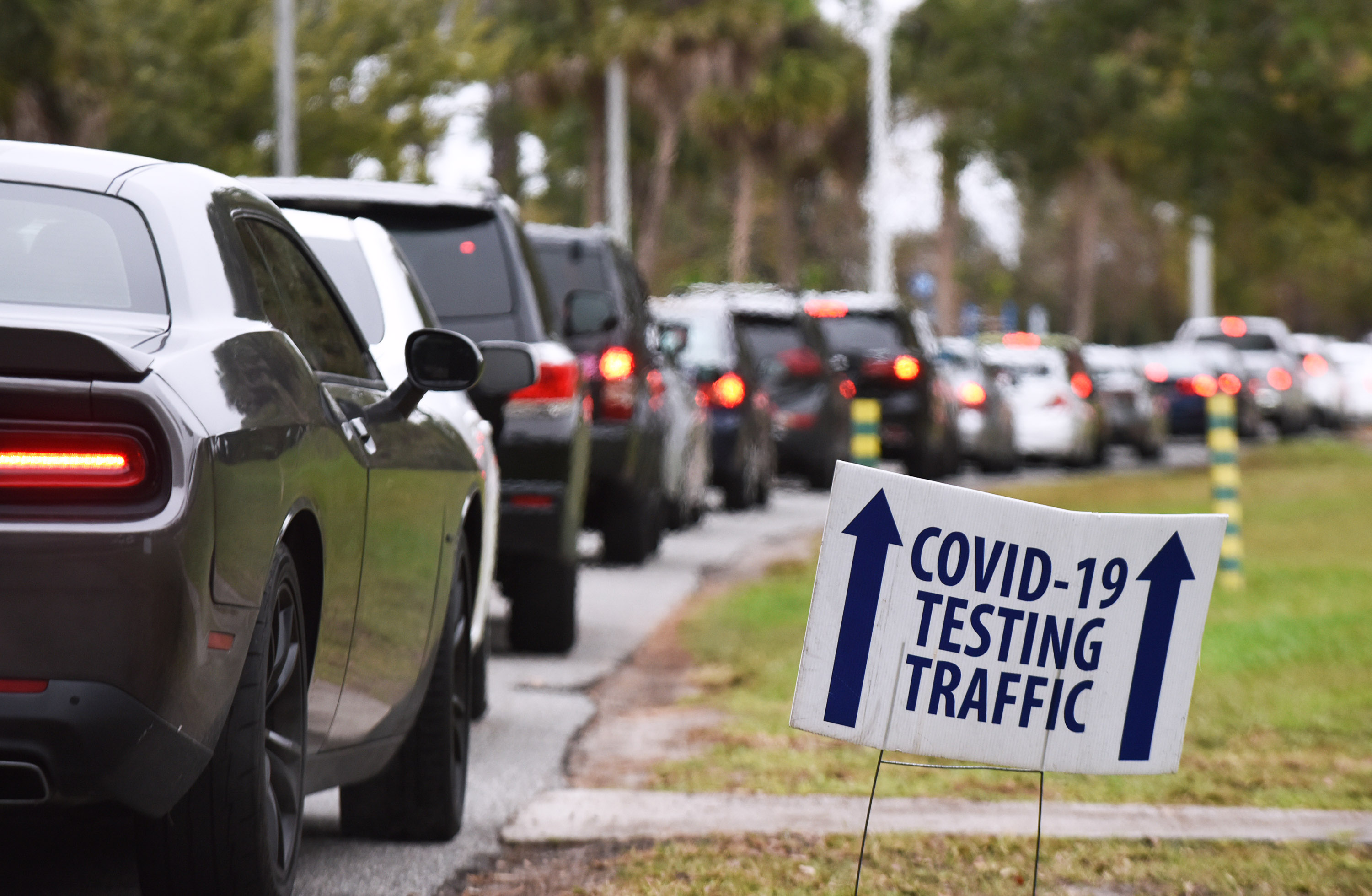 People wait in line at a Covid-19 testing and vaccination site in Orlando, Florida, on December 22.
