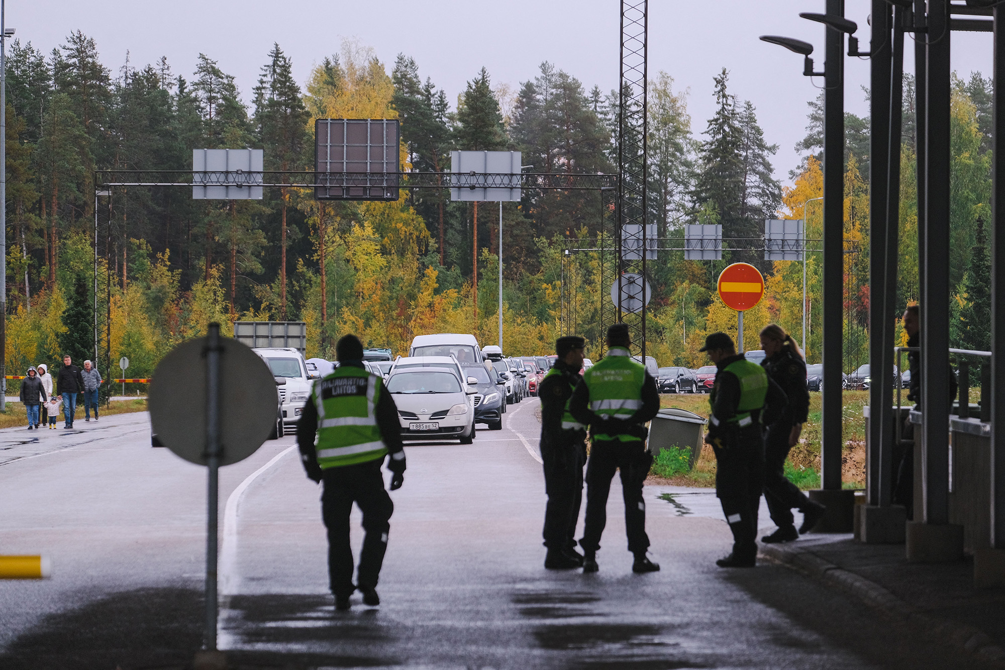 Finnish border guard officers look at cars queueing at the Vaalimaa border crossing between Finland and the Russian Federation on September 30.