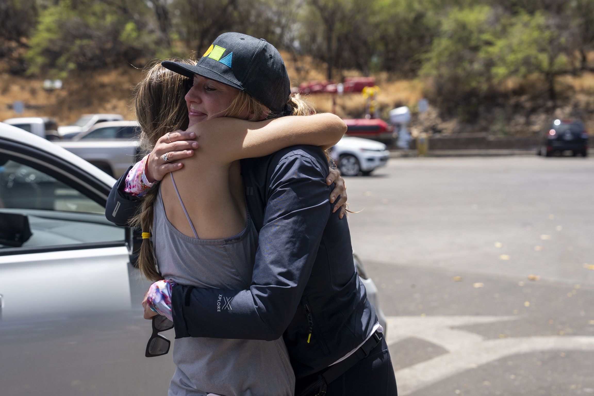 Grace Hurt, right, embraces someone while loading supplies for those in need Saturday at Kihei Ramp on Maui. "The reason why we are out here today is because we have ohana on the west side, boots on the ground that have no roof over their heads," Hurt said. "We are in an effort with the entire community here, we are trying to get them supplies directly."