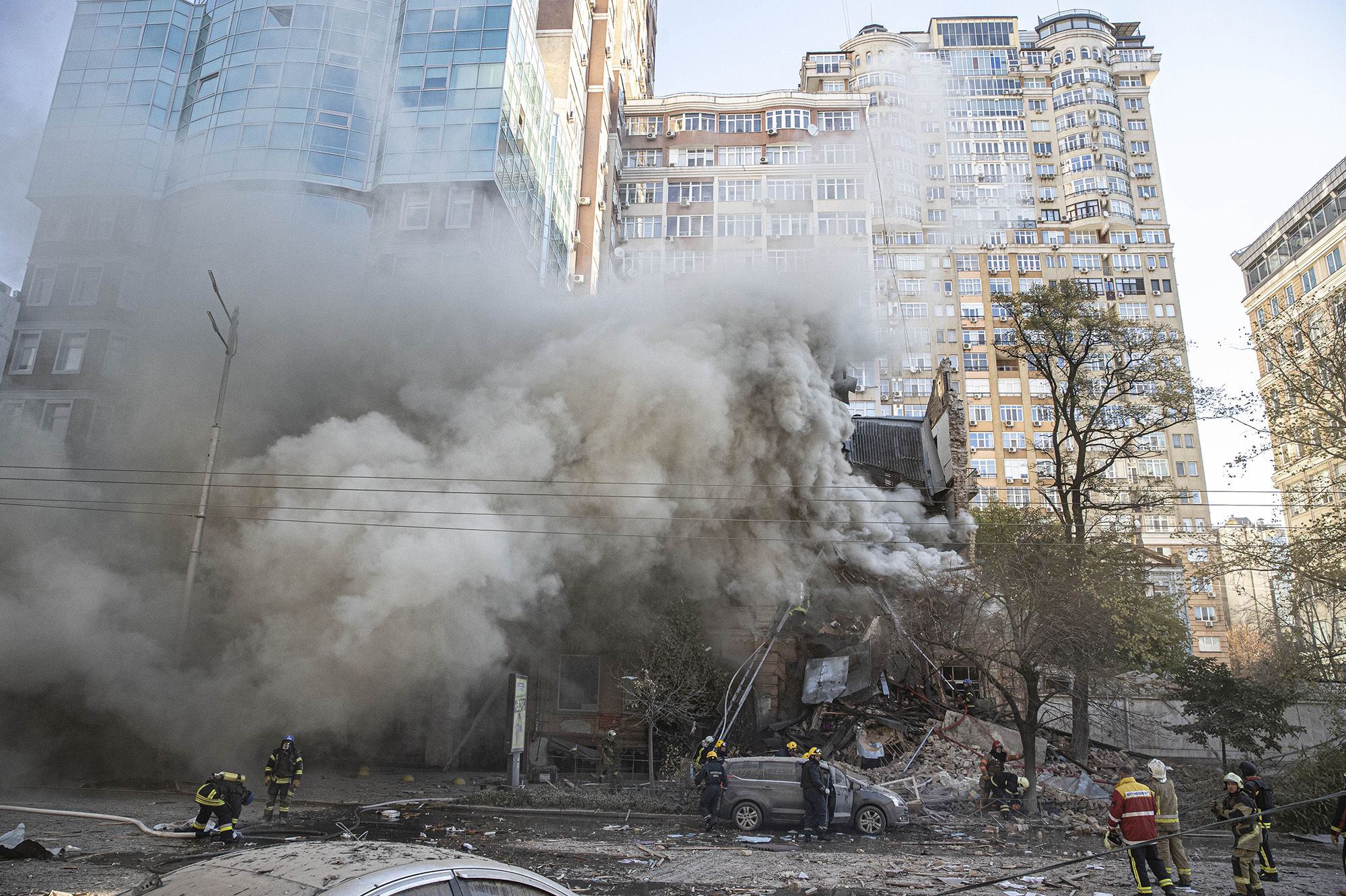 Firefighters attend to a building after Russian drone attacks in Kyiv, Ukraine, on October 17.