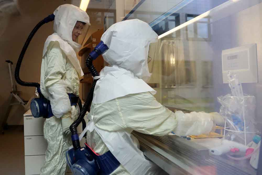 Scientists conduct research inside a laboratory at the Helmholtz Centre for Infection Research on May 25 in Braunschweig, Germany. The Helmholtz centre is conducting a variety of research into aspects of the current pandemic, including a possible vaccine. 