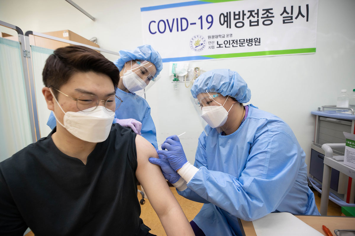 A health care worker at a nursing hospital in Ansan City is receiving an AstraZeneca vaccine on the first day of South Korea’s inoculation campaign on February 26.