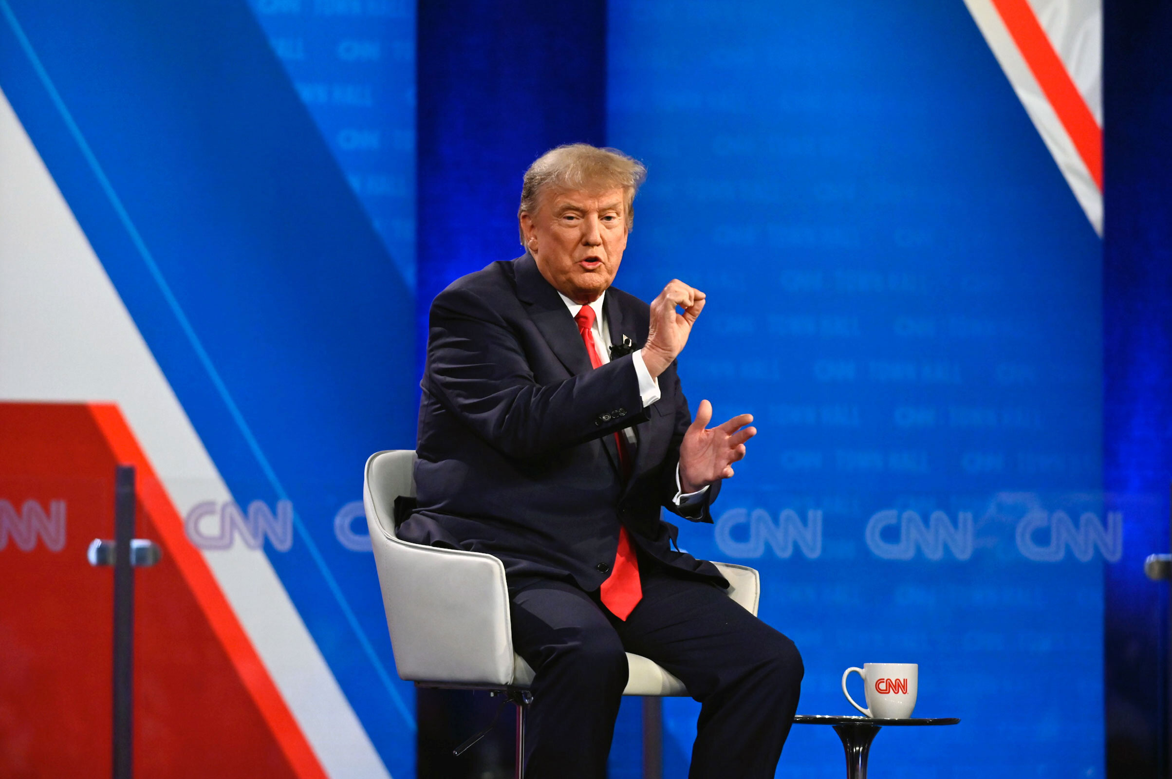Trump gestures while answering a question. 