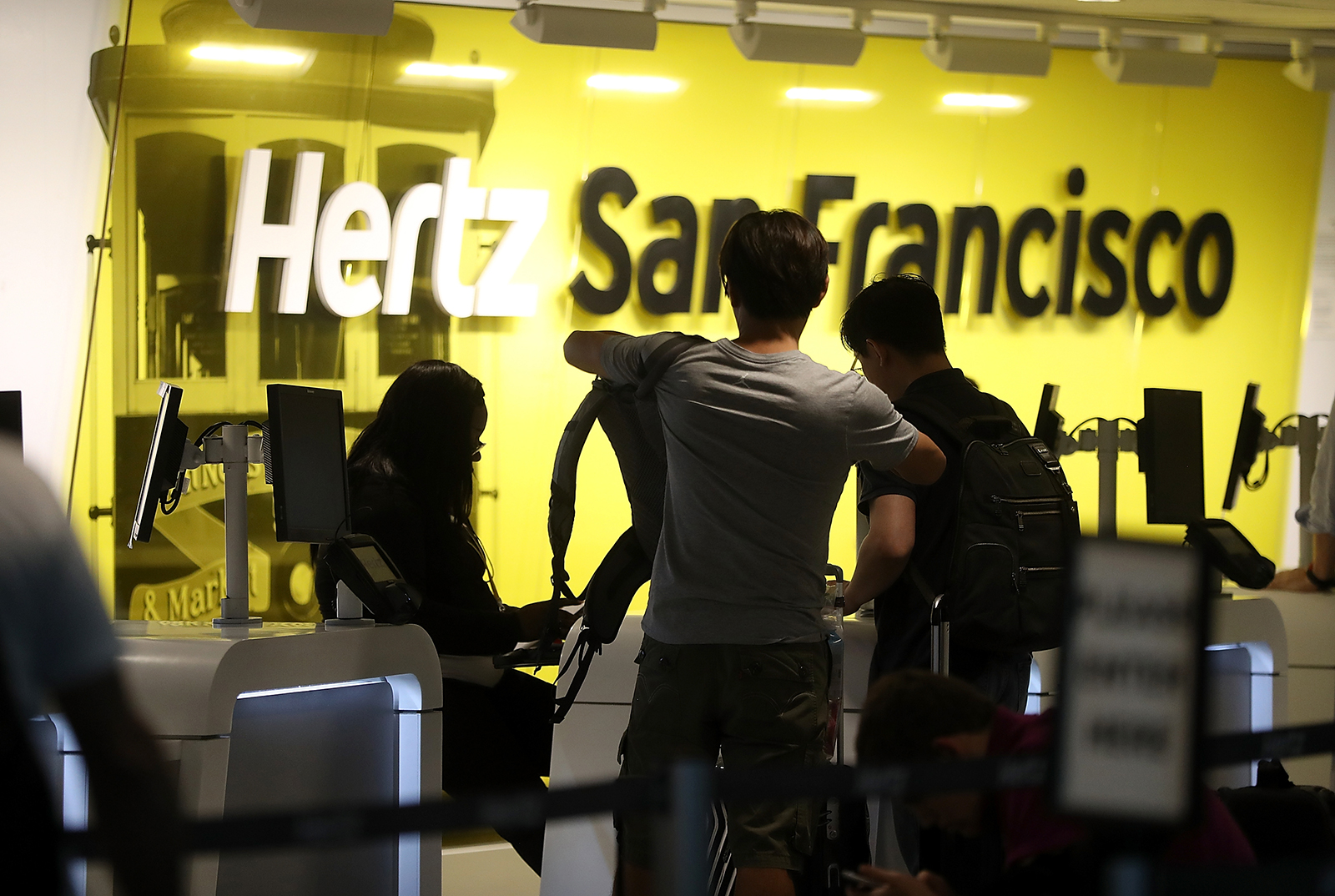 Customers are assisted at a Hertz rental car office on August 8, 2017 in San Francisco, California. 