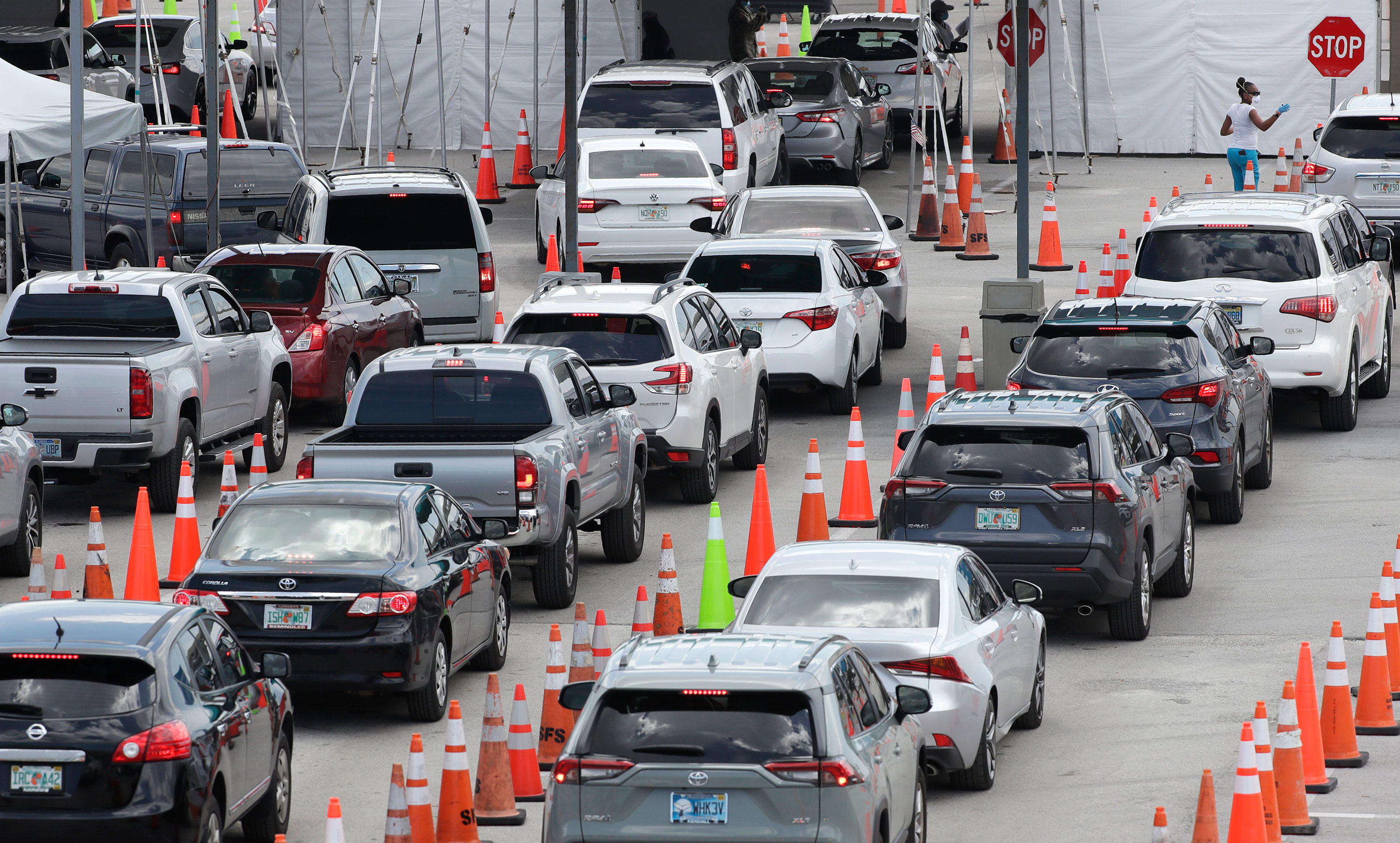 Vehicles wait in line at a drive-thru coronavirus testing site on July 8 in Miami Gardens, Florida.