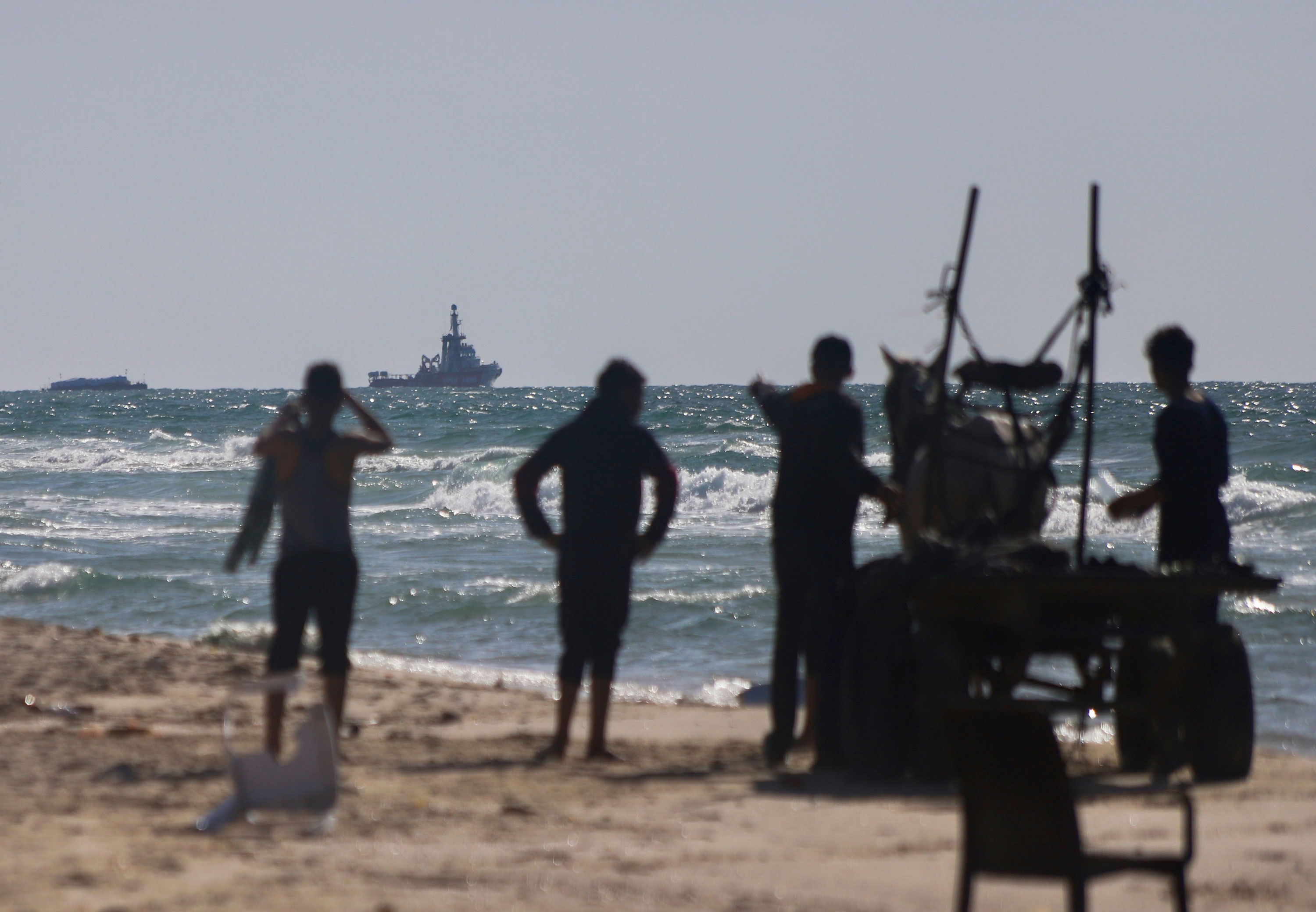 A ship belonging to the Open Arms aid group approaches the shores of Gaza towing a barge with 200 tons of humanitarian aid on Friday, March 15. 