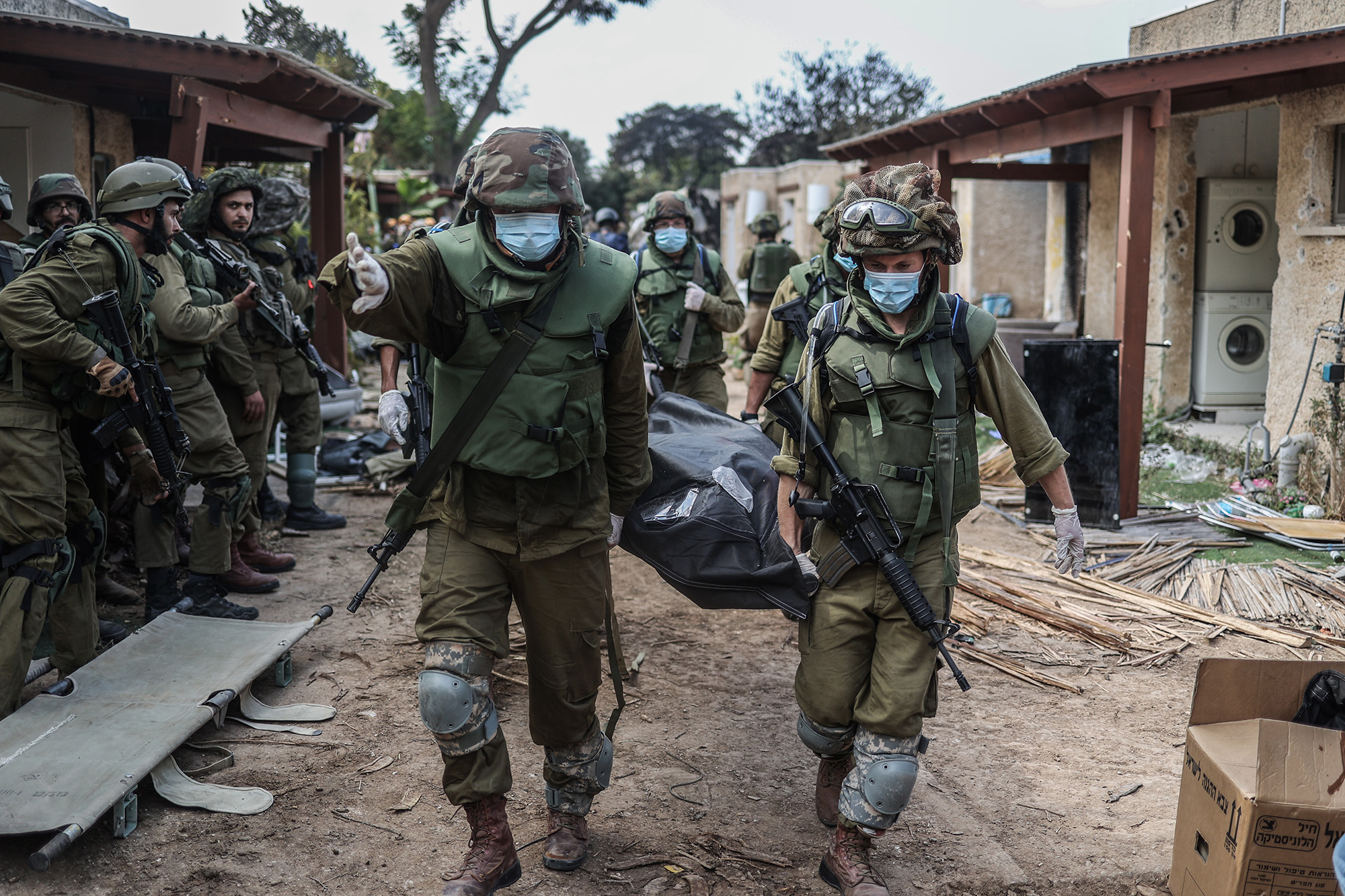 Israeli forces extract the dead bodies of Israeli residents from a destroyed house in Kfar Aza, Israel, on October 10.