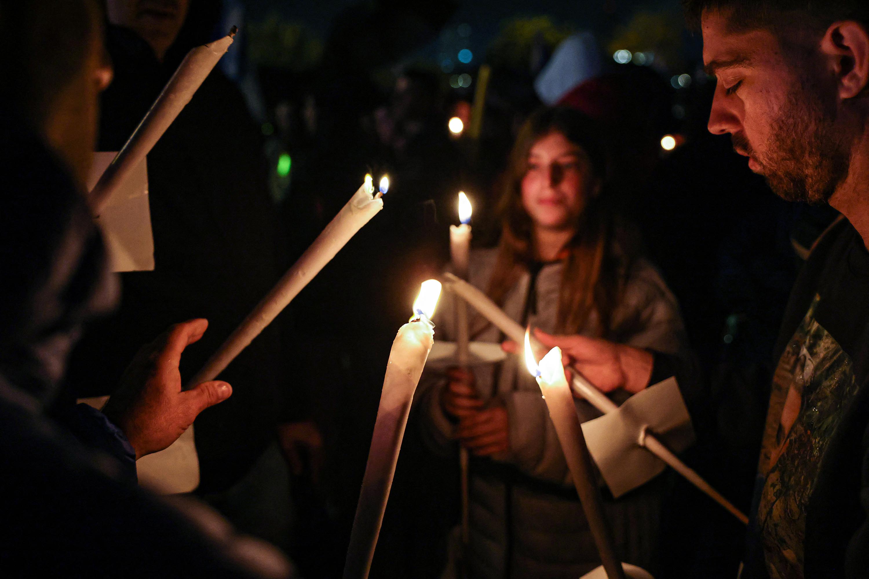 Families of hostages being held in Gaza join with members of the public in an evening march and protest around the Knesset to demand the government work to secure their return, on December 12, in Jerusalem. 