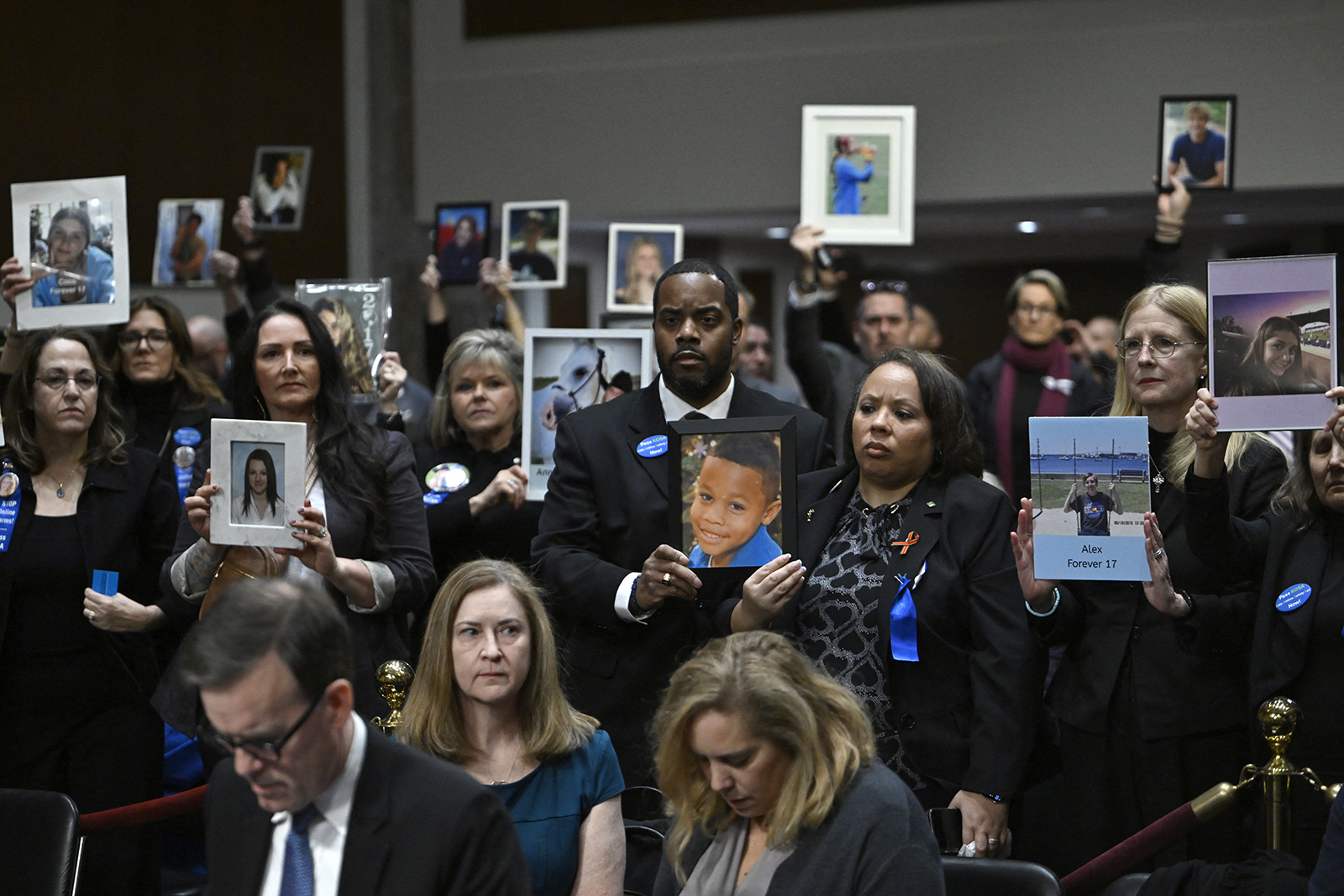 Relatives of victims hold their portraits before the start of the US Senate Judiciary Committee hearing, "Big Tech and the Online Child Sexual Exploitation Crisis," in Washington, DC, on January 31, 2024. 