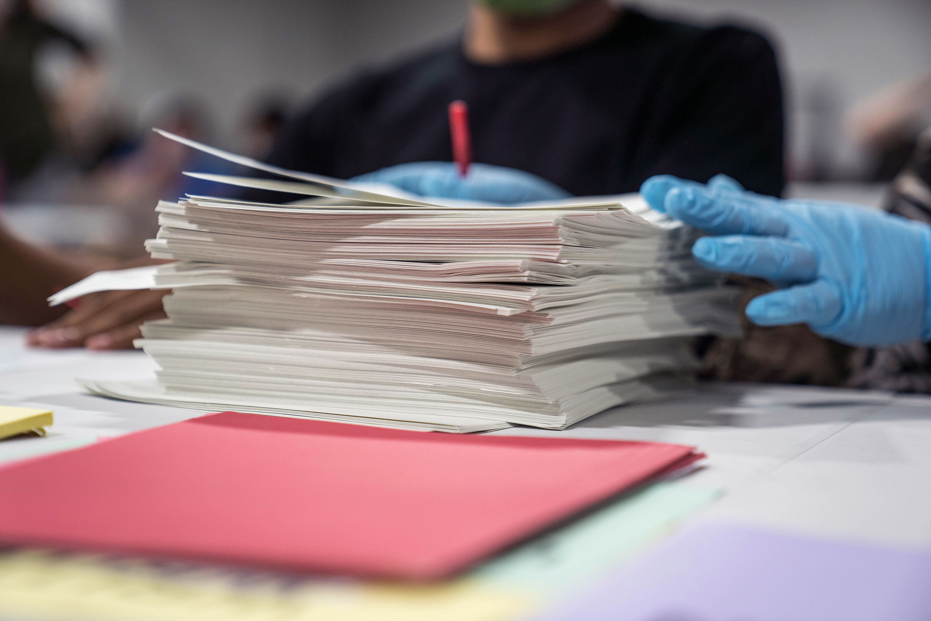 Gwinnett County election workers handle ballots as part of the recount for the 2020 presidential election on November 16 in Lawrenceville, Georgia. 