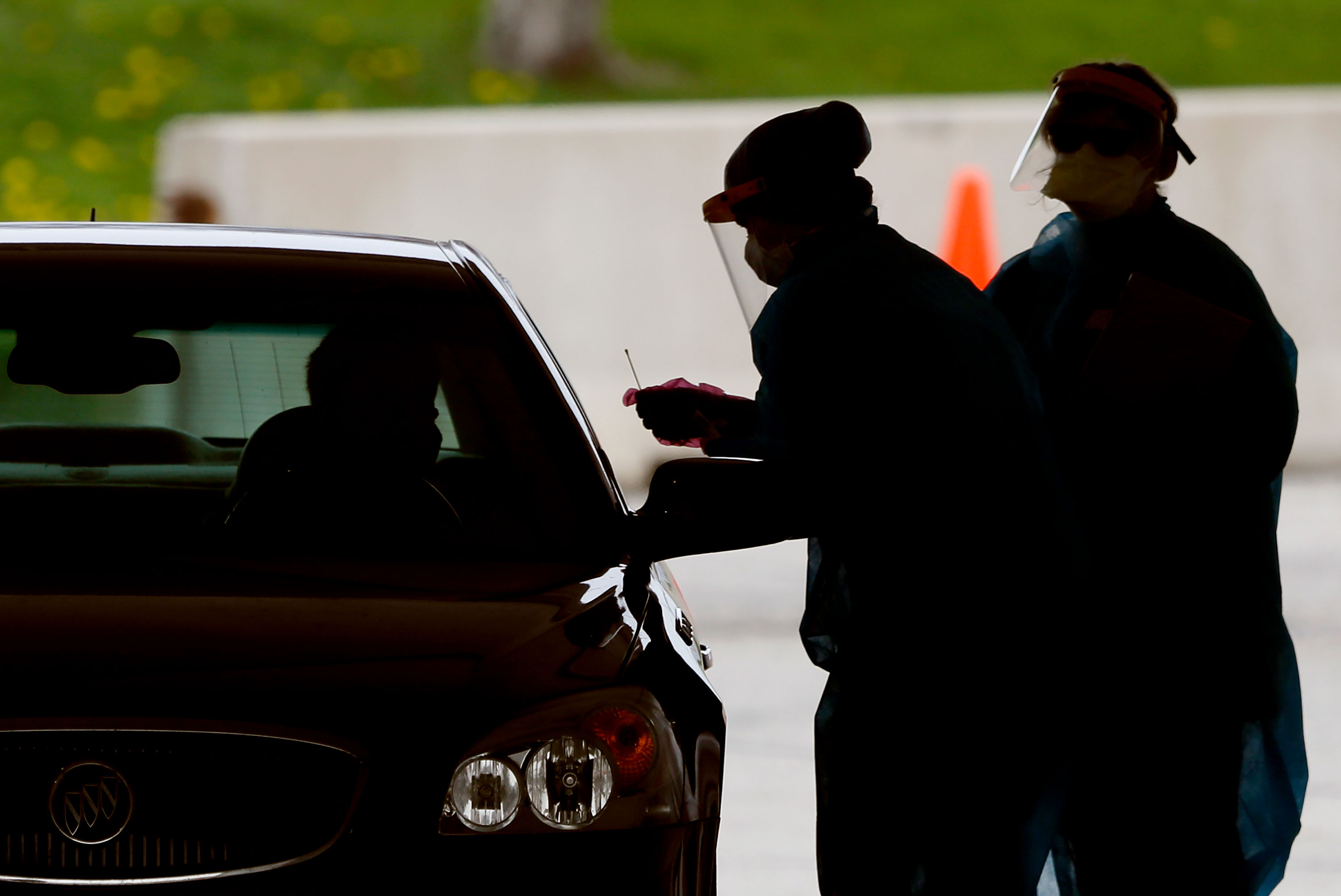 Medical workers test a local resident at a drive-thru Covid-19 testing site in Waterloo, Iowa on May 1.