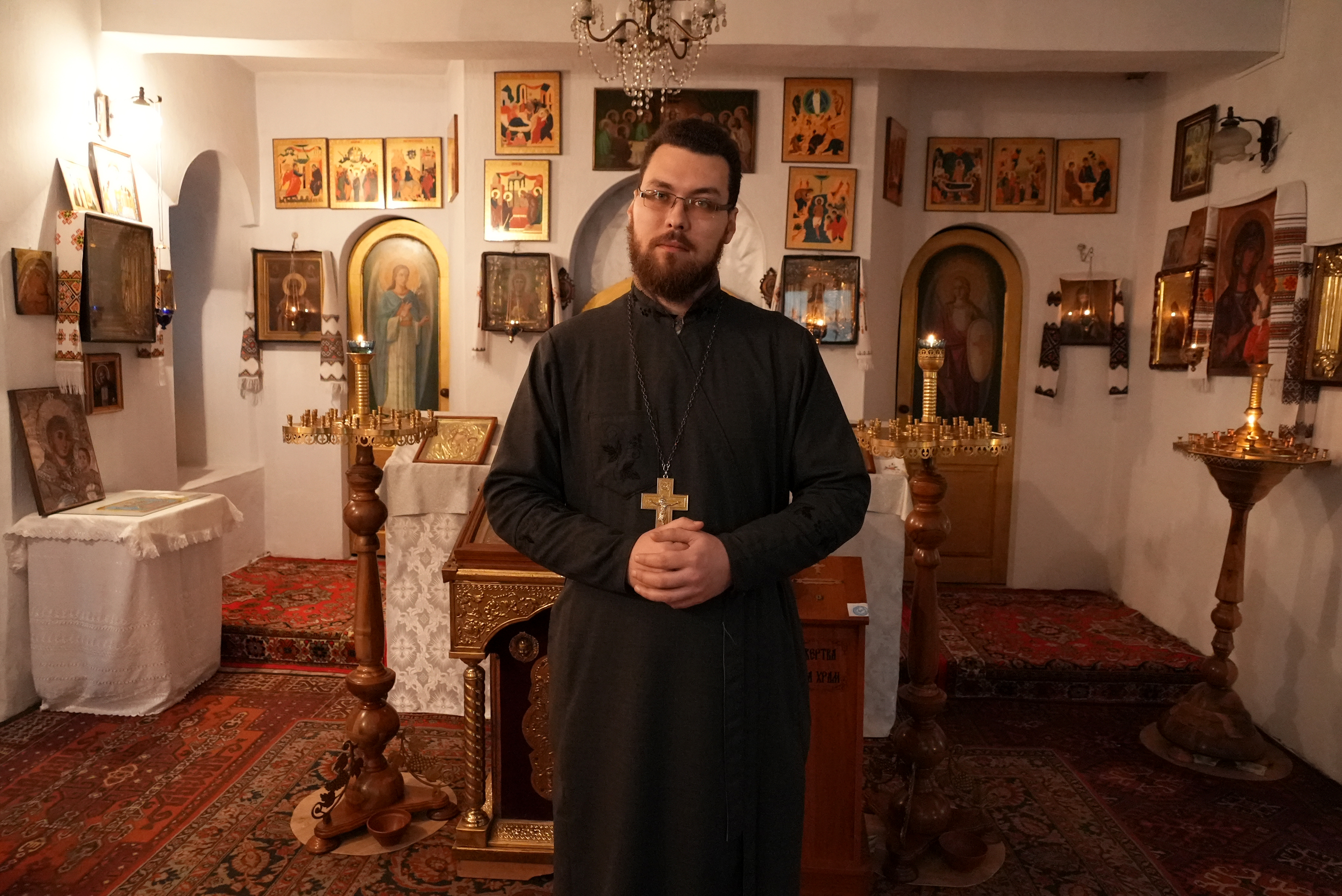 Roman Peretyatko, who serves as both a civilian and military chaplain, stands in his church, Archangel St. Michael, in Mariupol, Ukraine. 