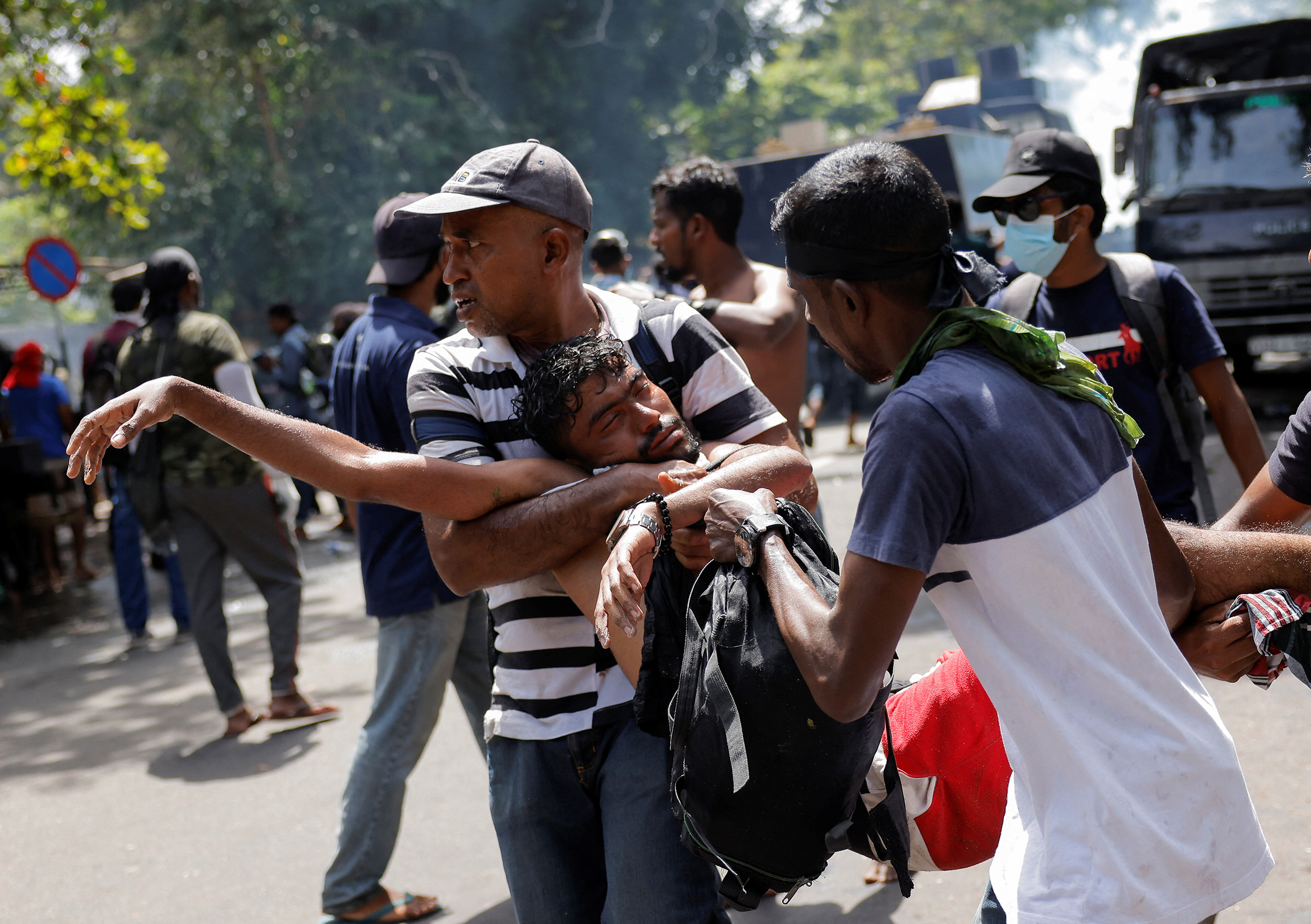 Demonstrators carry an injured person during a clash in front of Sri Lankan Prime Minister Ranil Wickremasinghe's office in Colombo, Sri Lanka, on July 13.
