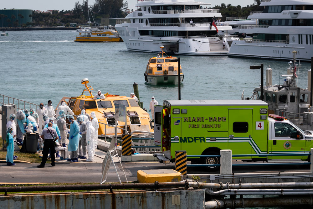 Medical staff attend suspected Covid-19 patients as they arrive at US Coast Guard Base Miami Beach on March 26 in Miami, Florida.