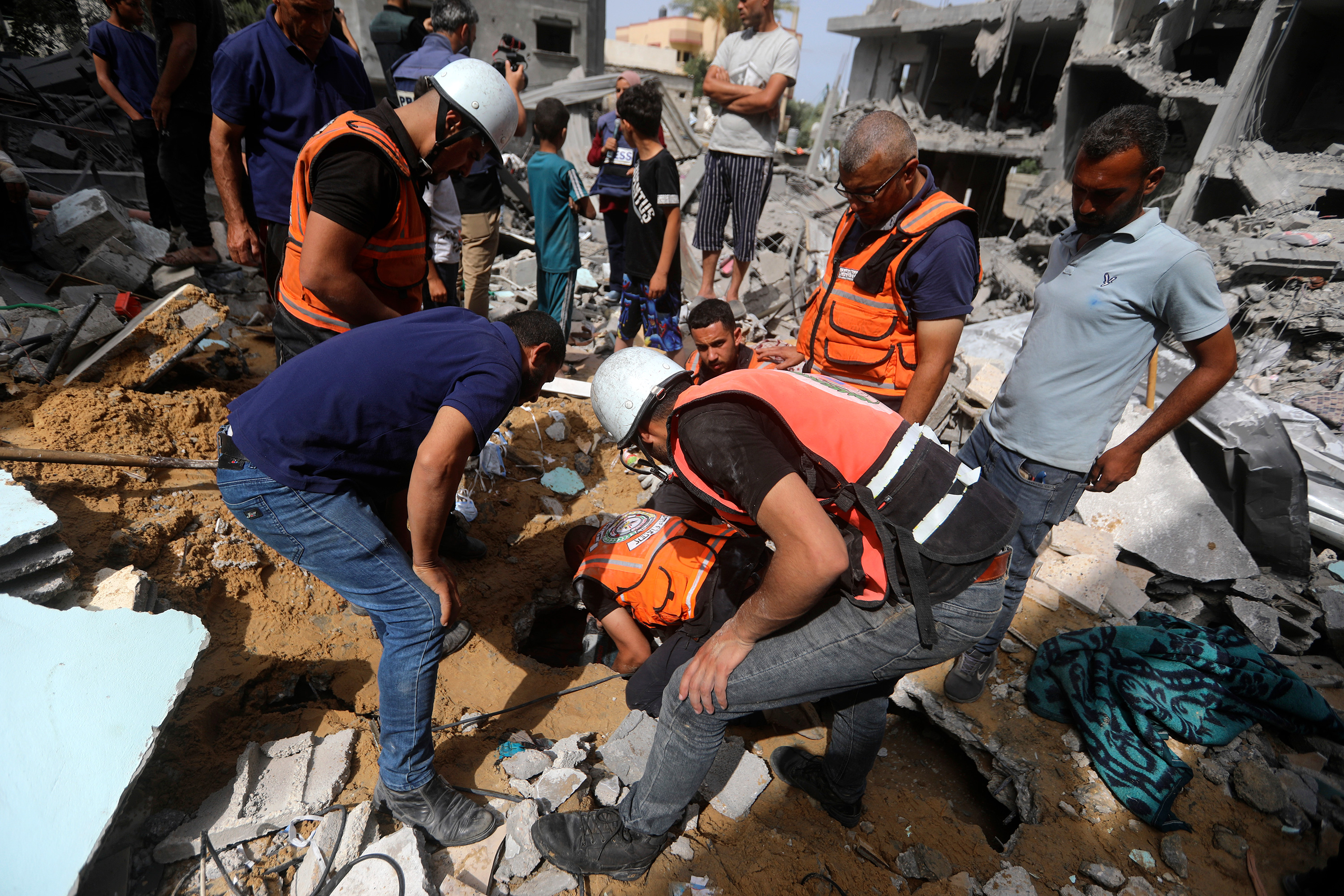 Palestinians search for survivors after an Israeli airstrike in Nuseirat refugee camp in Gaza, on May 19. 