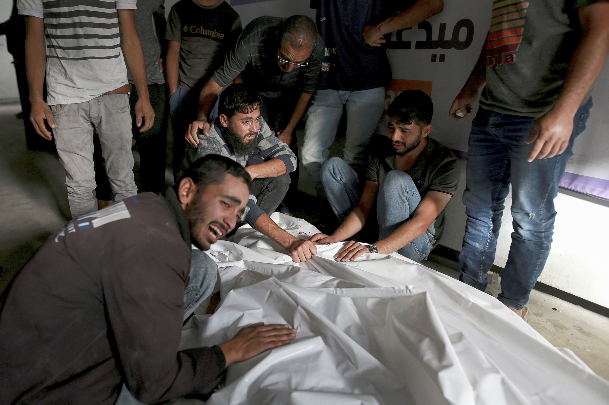 Palestinians at a morgue mourn over the bodies of relatives killed in an Israeli airstrike in Rafah, Gaza, on May 27.