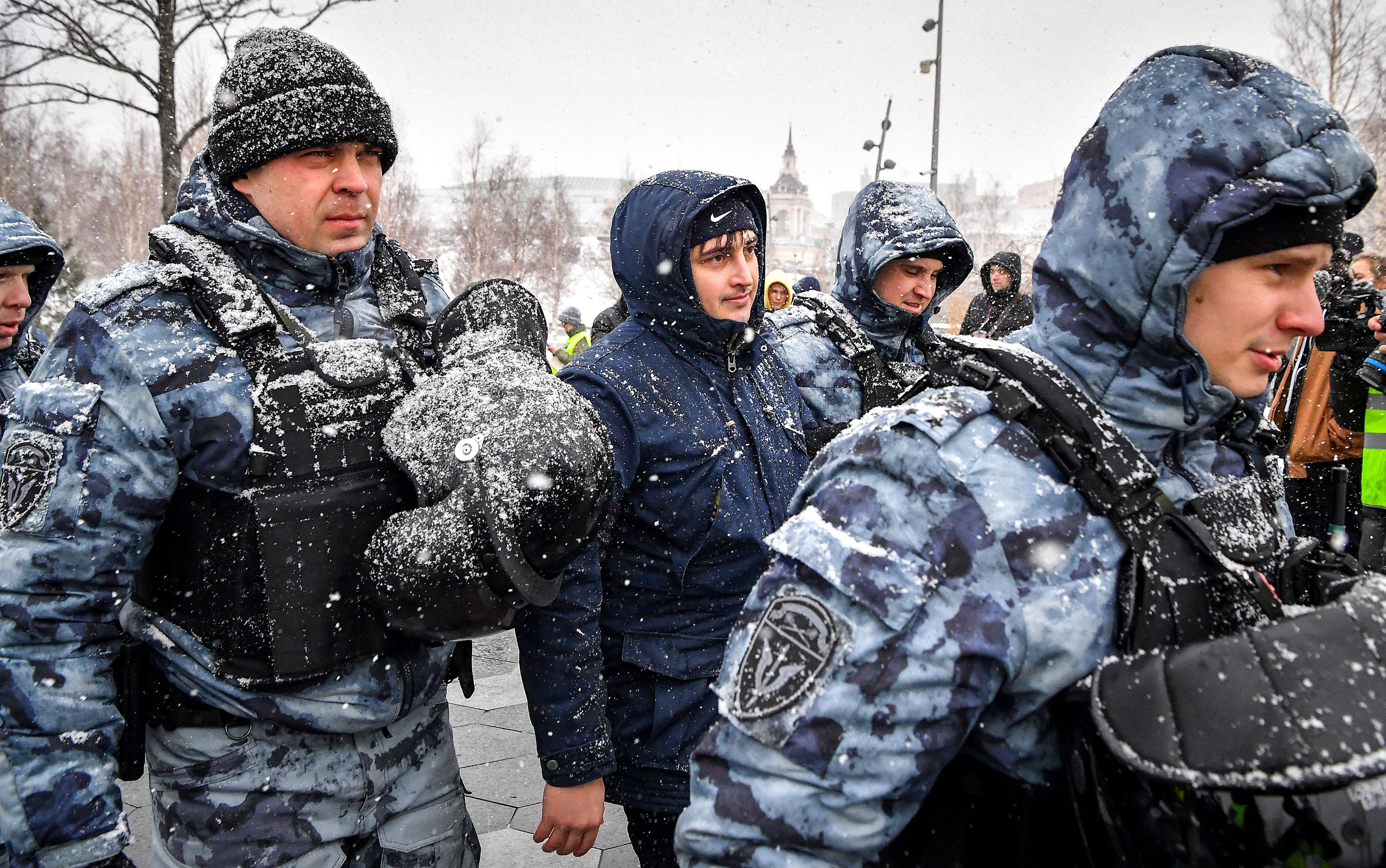 Police officers detain a man during a protest against Russian military action in Ukraine, in central Moscow on April 2.