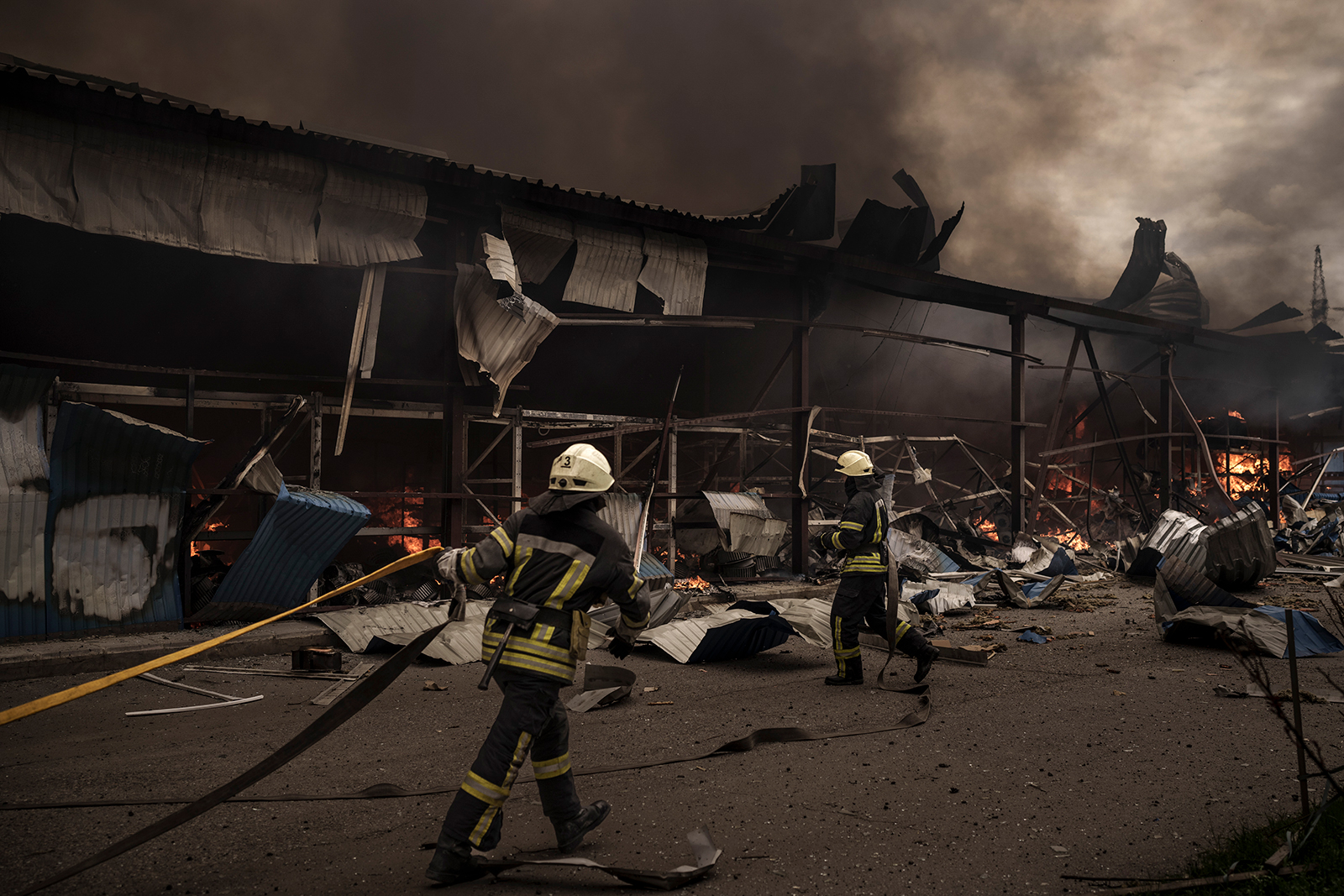 Firefighters work to put out a fire at a warehouse in the middle of Russian bombings in Kharkiv, Ukraine, on Saturday, April 23.