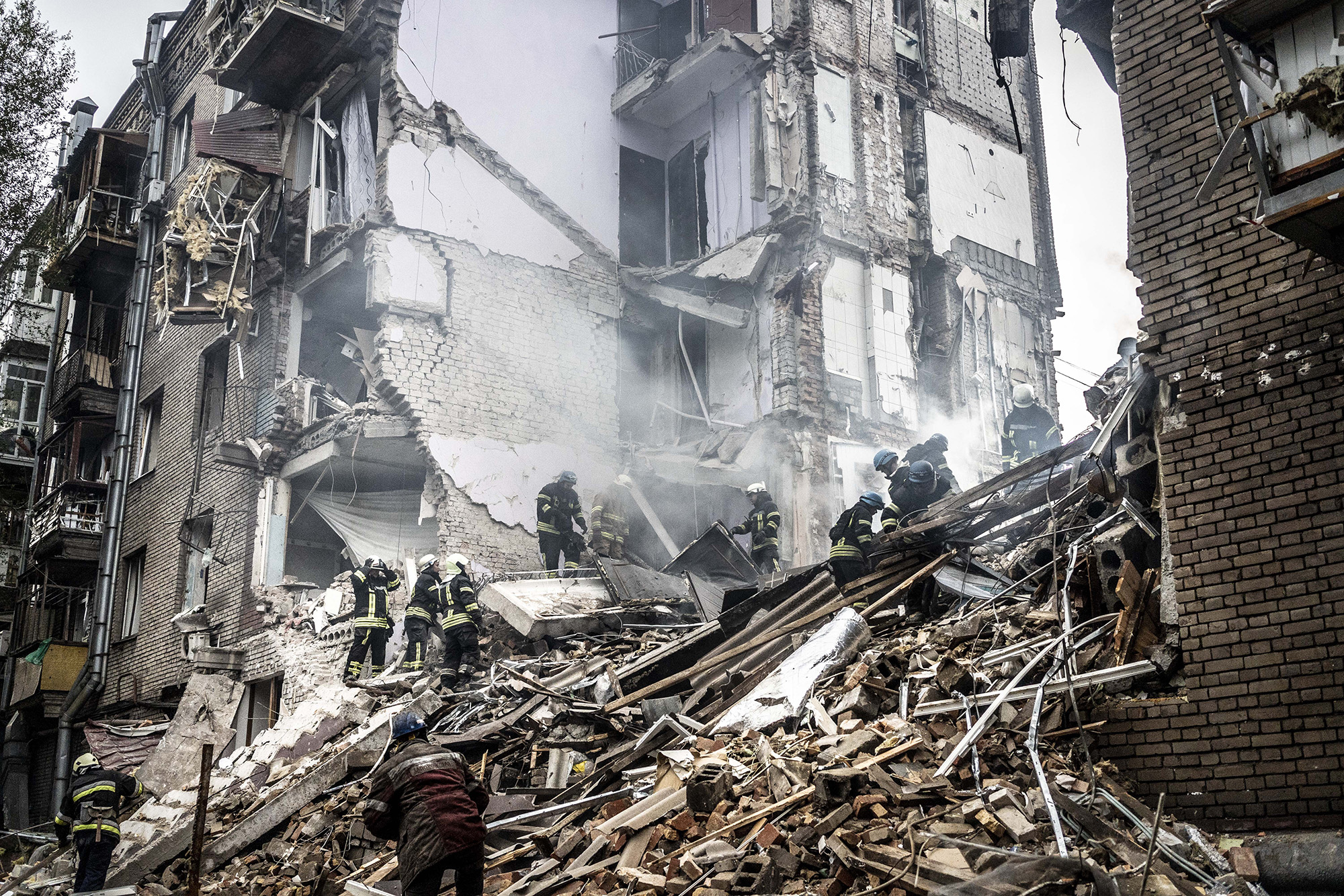 Firefighters conduct work in a damaged building after a Russian missile attack in Zaporizhzhia, Ukraine on October 10.