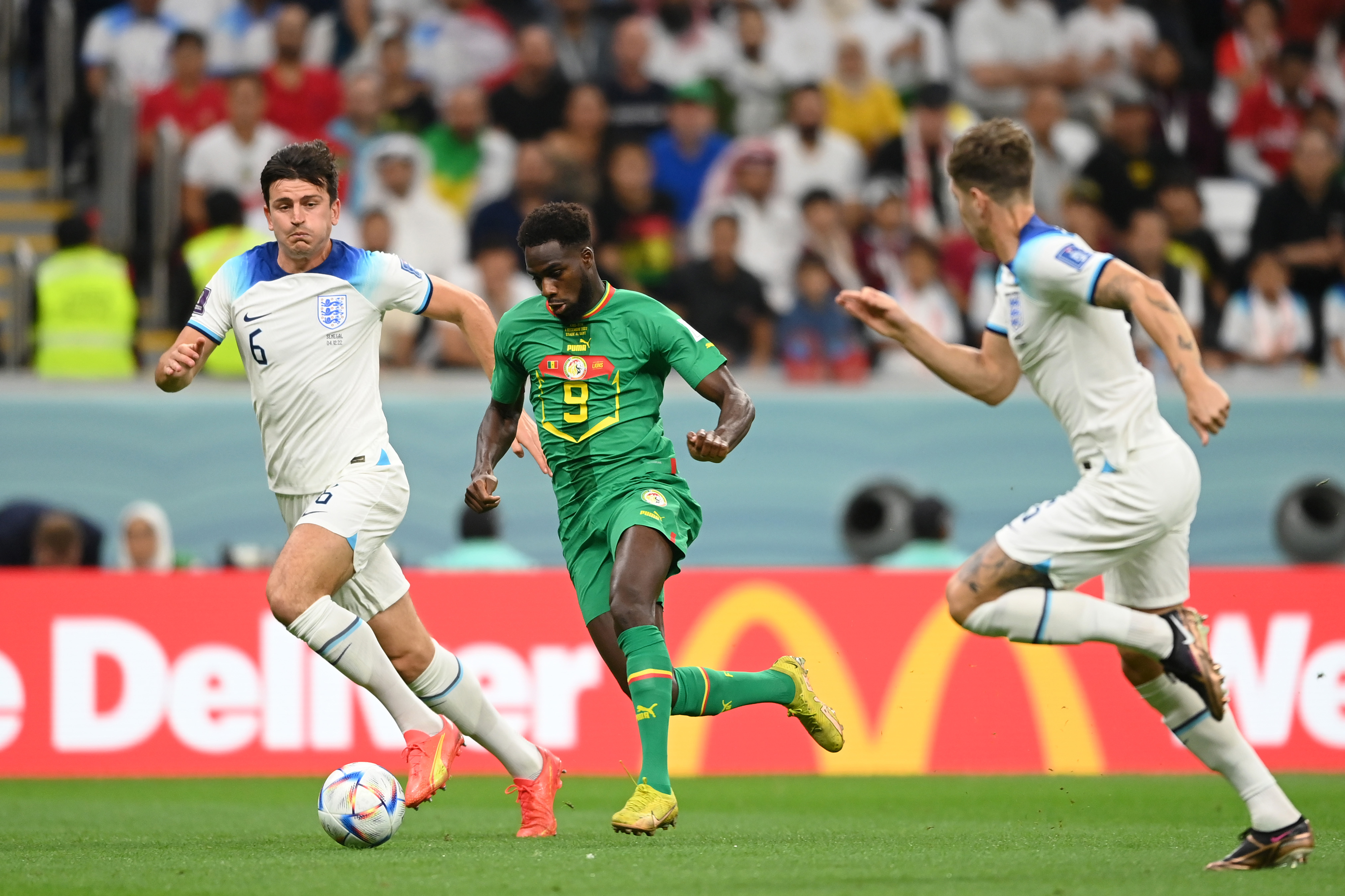 Boulaye Dia of Senegal is challenged by Harry Maguire of England during the match between England and Senegal at Al Bayt Stadium in Al Khor, Qatar on Sunday.