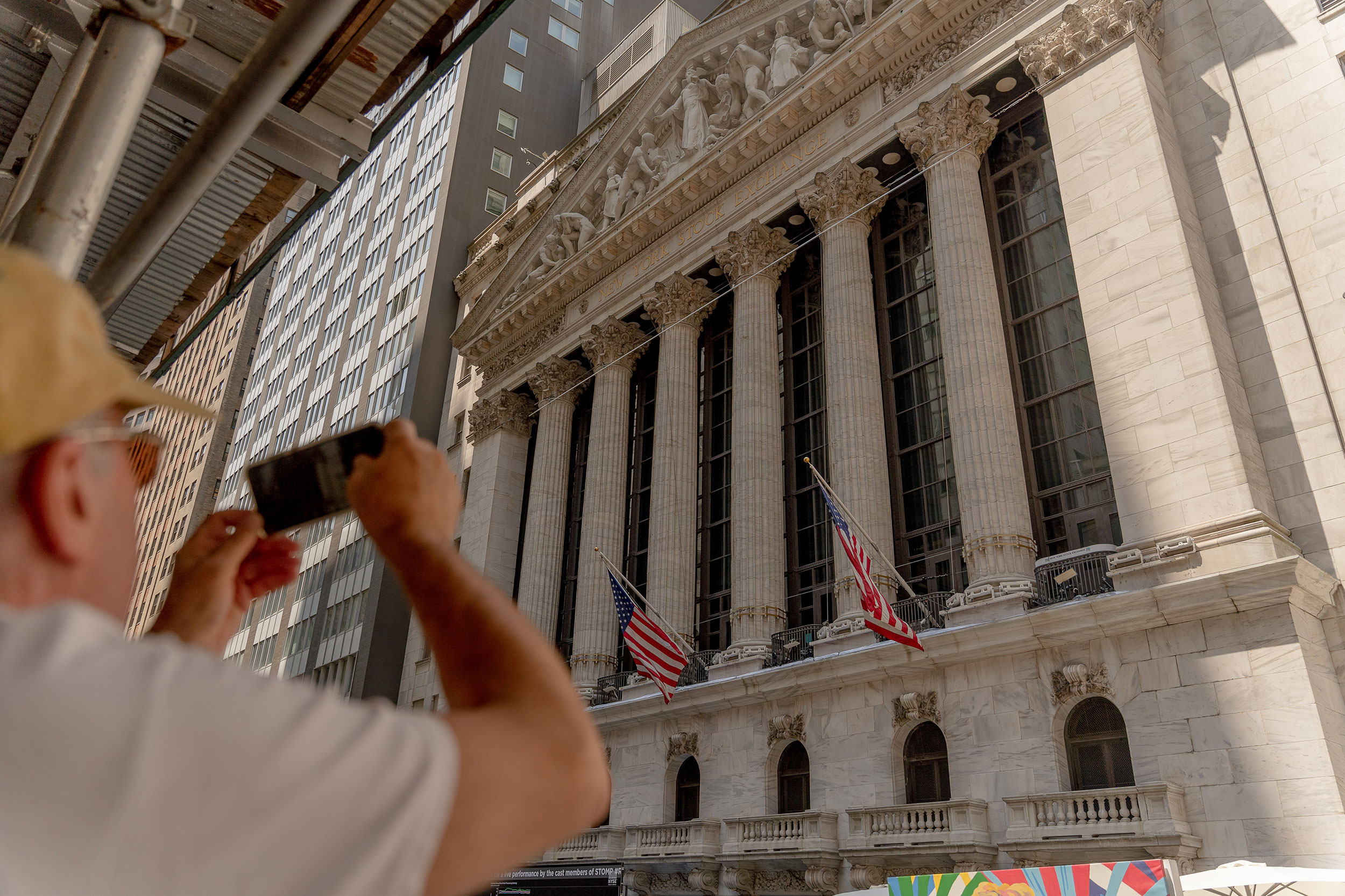 A man photographs the New York Stock Exchange on Thursday, July 15.