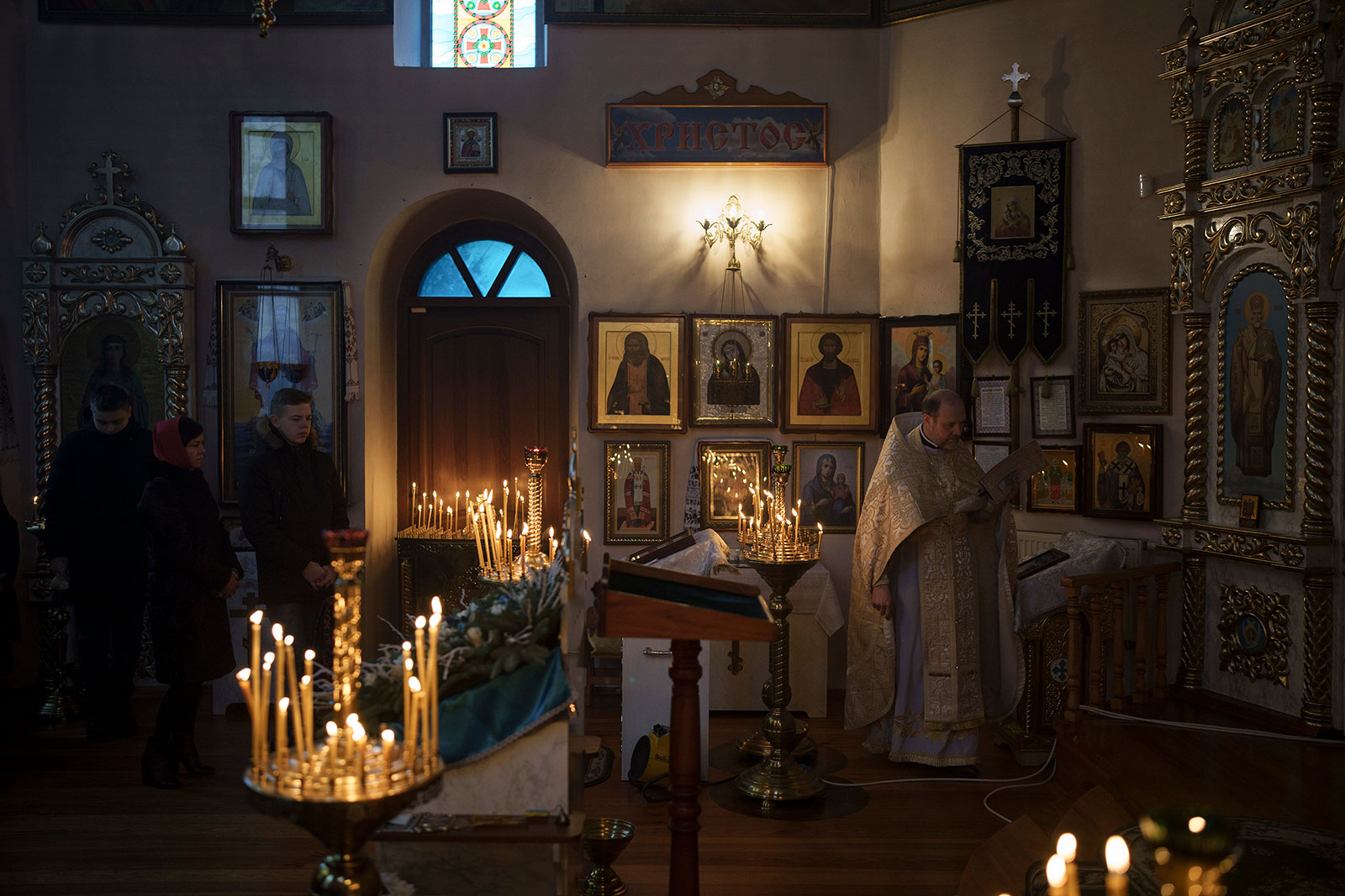 Ukrainians attend a Christmas mass at an Orthodox church in the outskirts of Kyiv, Ukraine, on Sunday, December 25. 