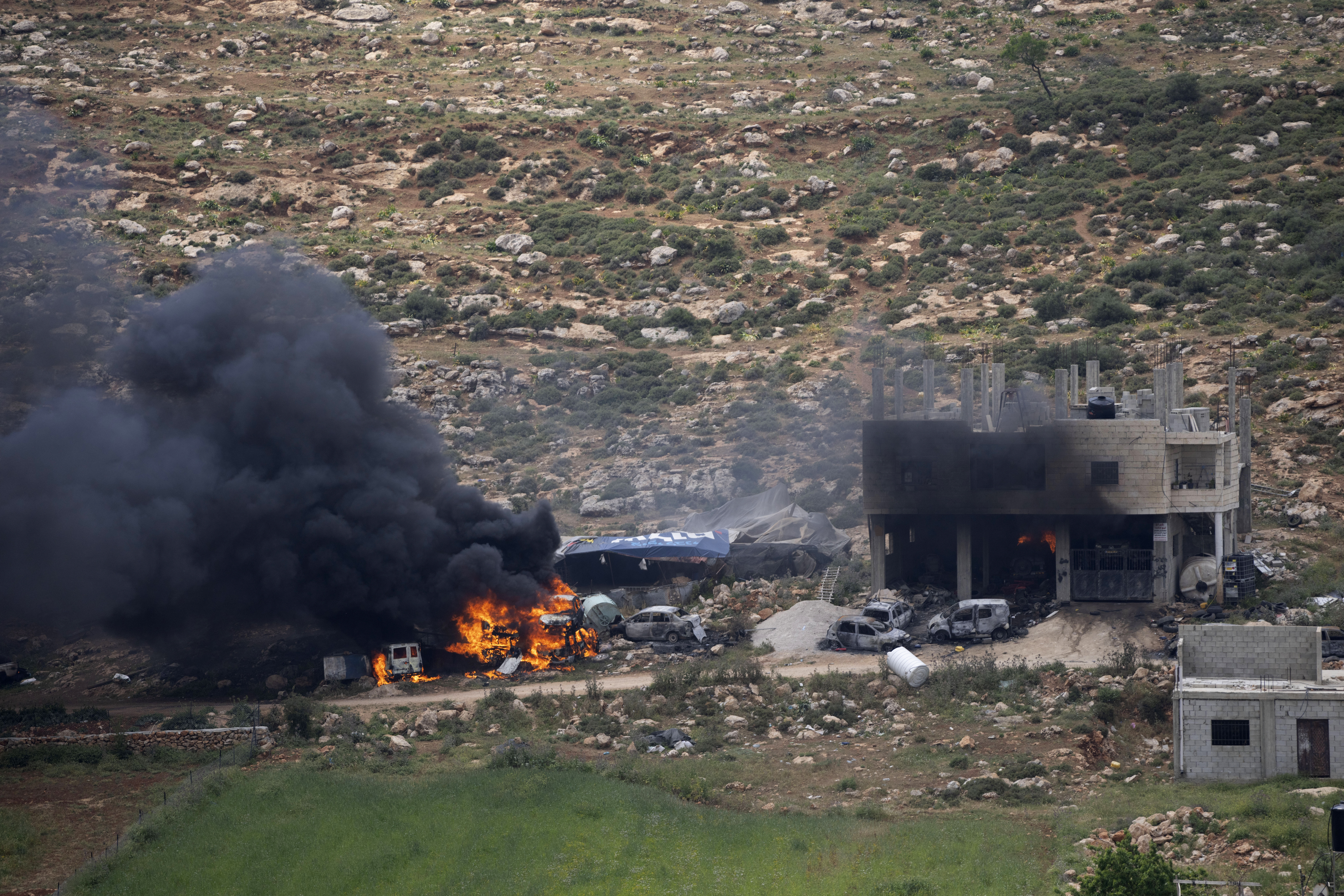 Properties of Palestinian villagers are set on fire by Israeli settlers in the West Bank village of Al-Mughayyir on April 13.