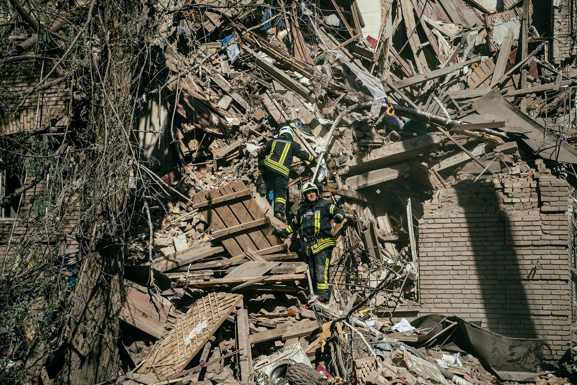 Ukrainian firefighters looking for survivors in the rubble after a missile strike in Zaporizhzhia, Ukraine, on October 6.