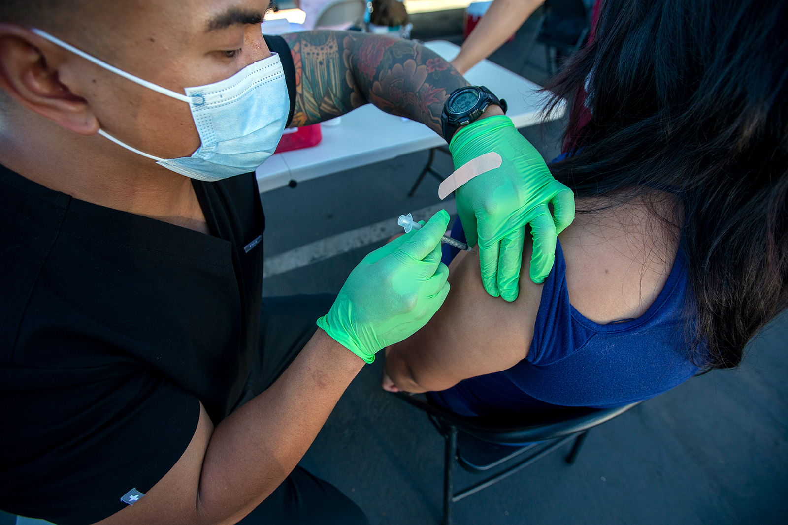 Marc Ocampo administers a vaccine to DIana Vuevas at a Covid-19 vaccination clinic Long Beach City College Pacific Coast Campus. on Tuesday, July 6, 2021 in Long Beach, California.