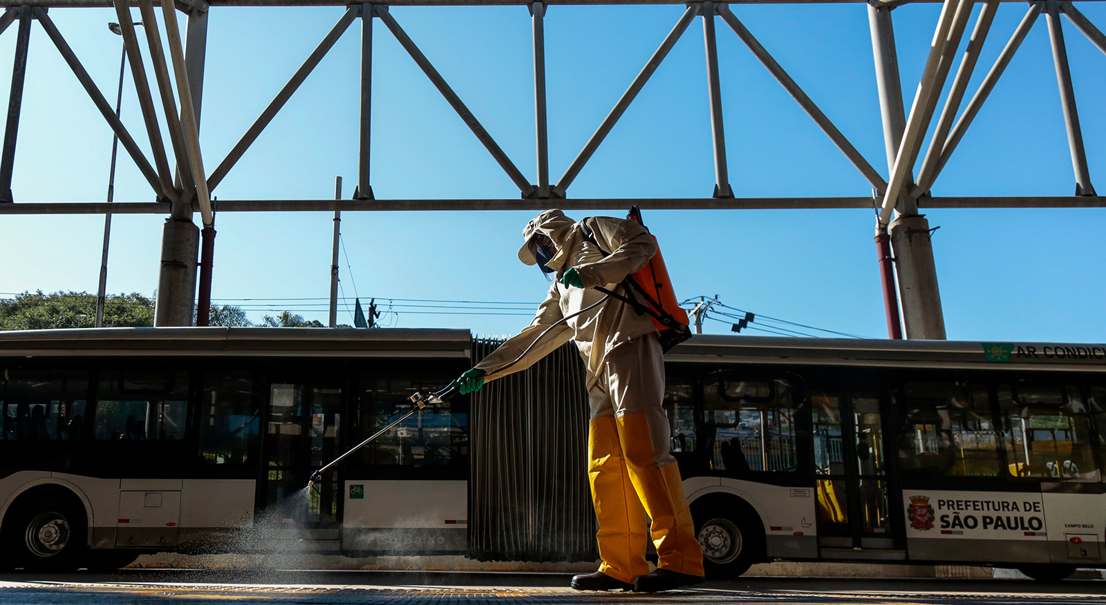 A member of a municipal sanitization crew sprays disinfectant at a bus terminal on May 25, in Sao Paulo, Brazil. 