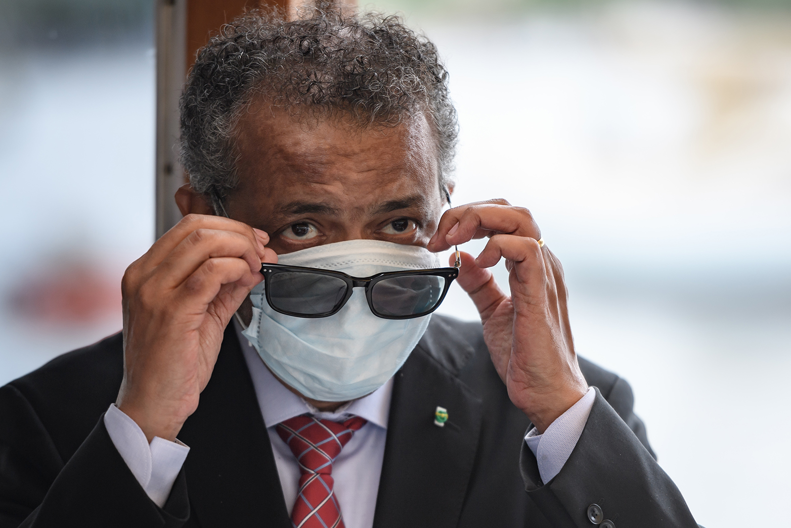 World Health Organization Director-General Tedros Adhanom Ghebreyesus wears a mask after leaving a ceremony of the restarting of Geneva's landmark fountain, known as "Jet d'Eau" on Thursday, June 11, in Geneva.