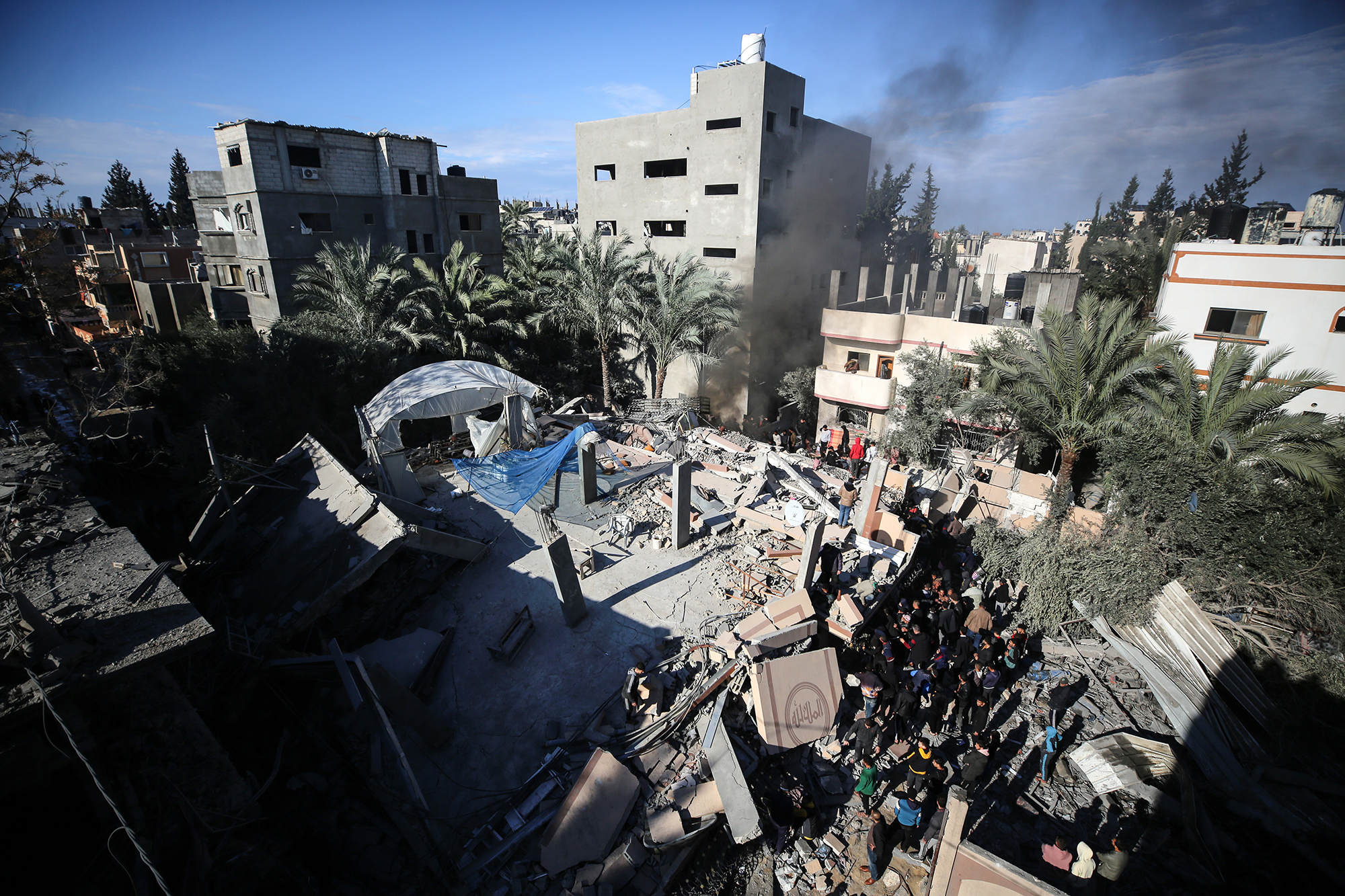Palestinians inspect the damage in Deir Al-Balah, central Gaza, on February 4, following an Israeli strike.