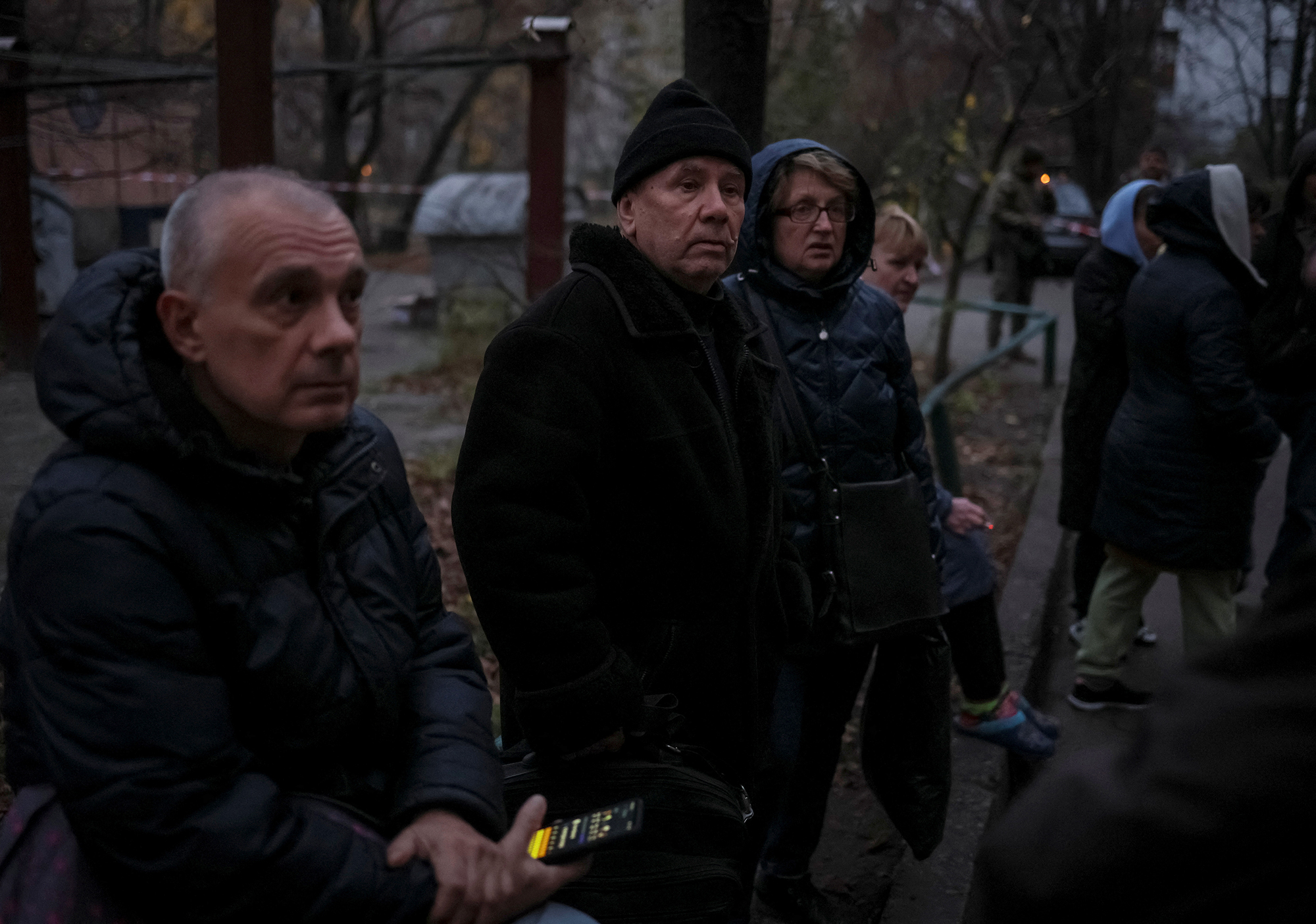 Local residents gather near their residential building hit by a Russian missile strike in Kyiv, Ukraine, on November 15.