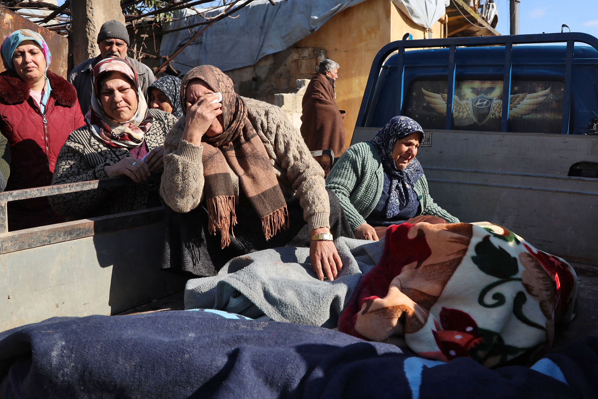 Women weep next to bodies lying on the back of a truck in Jandaris, Syria, on February 7.