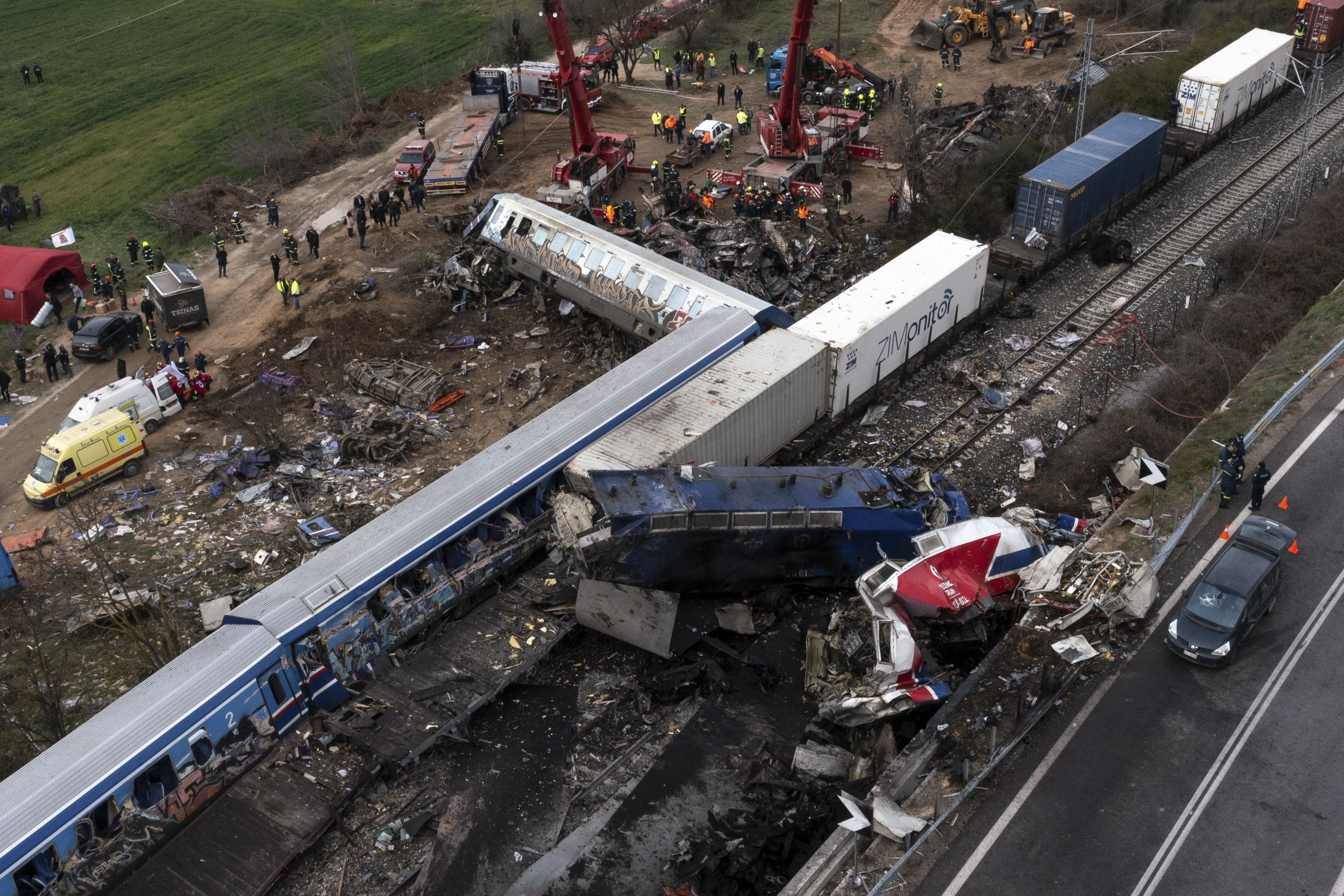 Emergency responders work at the site where a passenger train and freight train collided head-on in Tempi, central Greece, near the city of Larissa.
