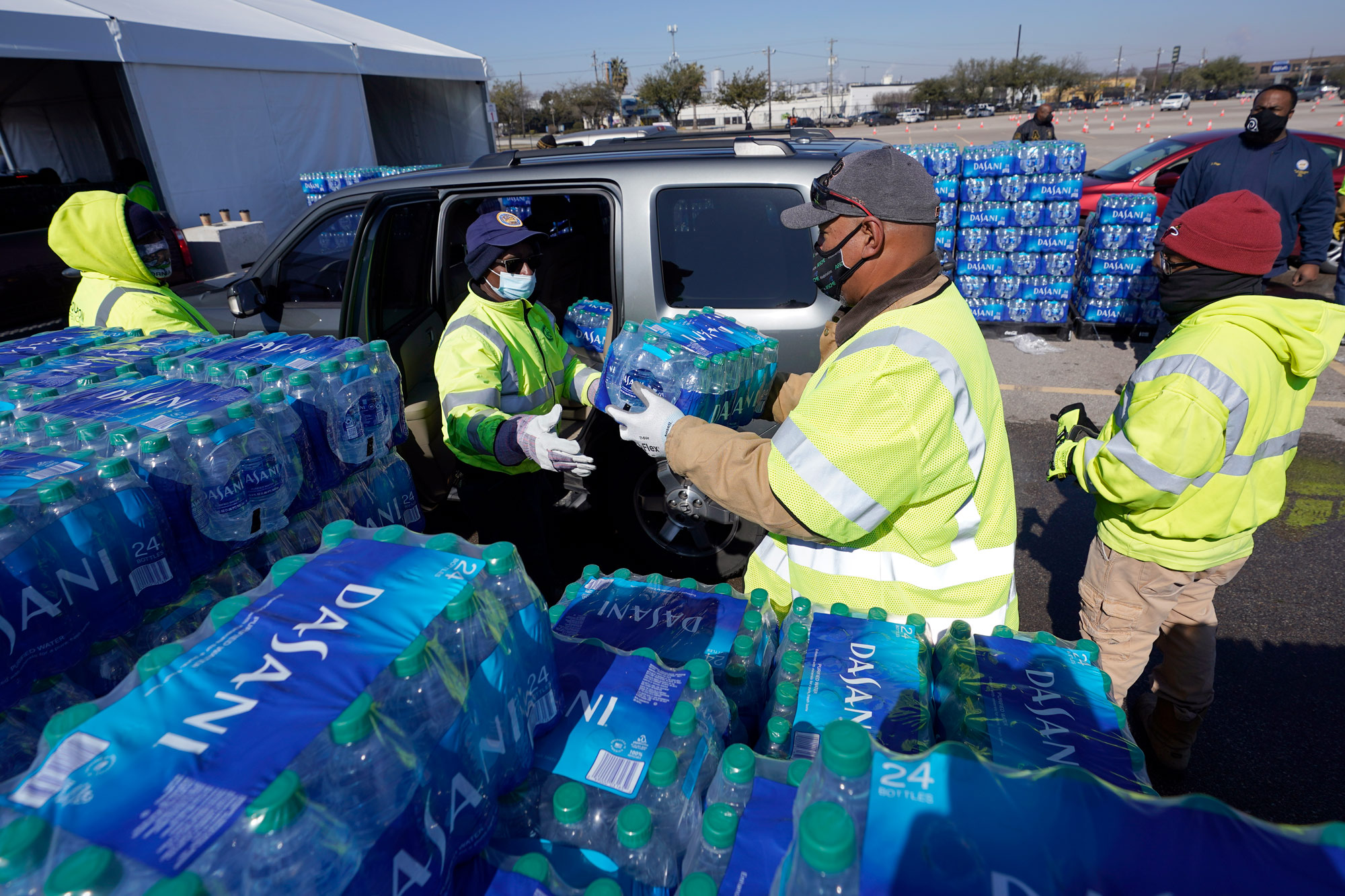 Water is loaded into a vehicle at a water distribution site on February 19 in Houston, Texas.
