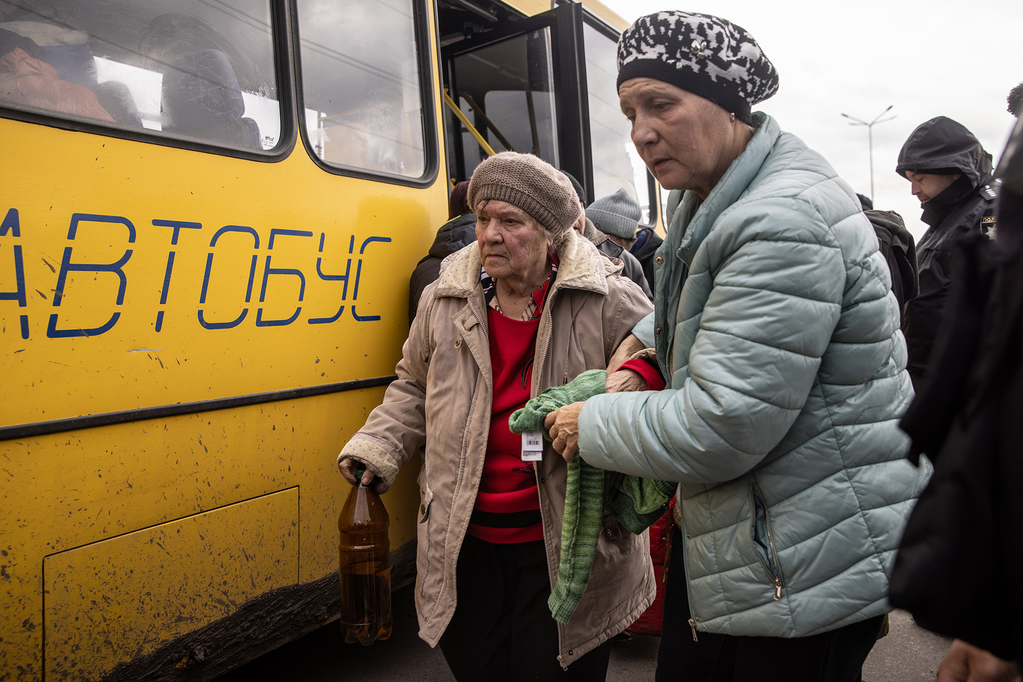 Women from Mariupol disembark at an evacuation point, carrying people from Mariupol, Melitopol and surrounding towns under Russian control, on April 21, in Zaporizhzhia, Ukraine. 