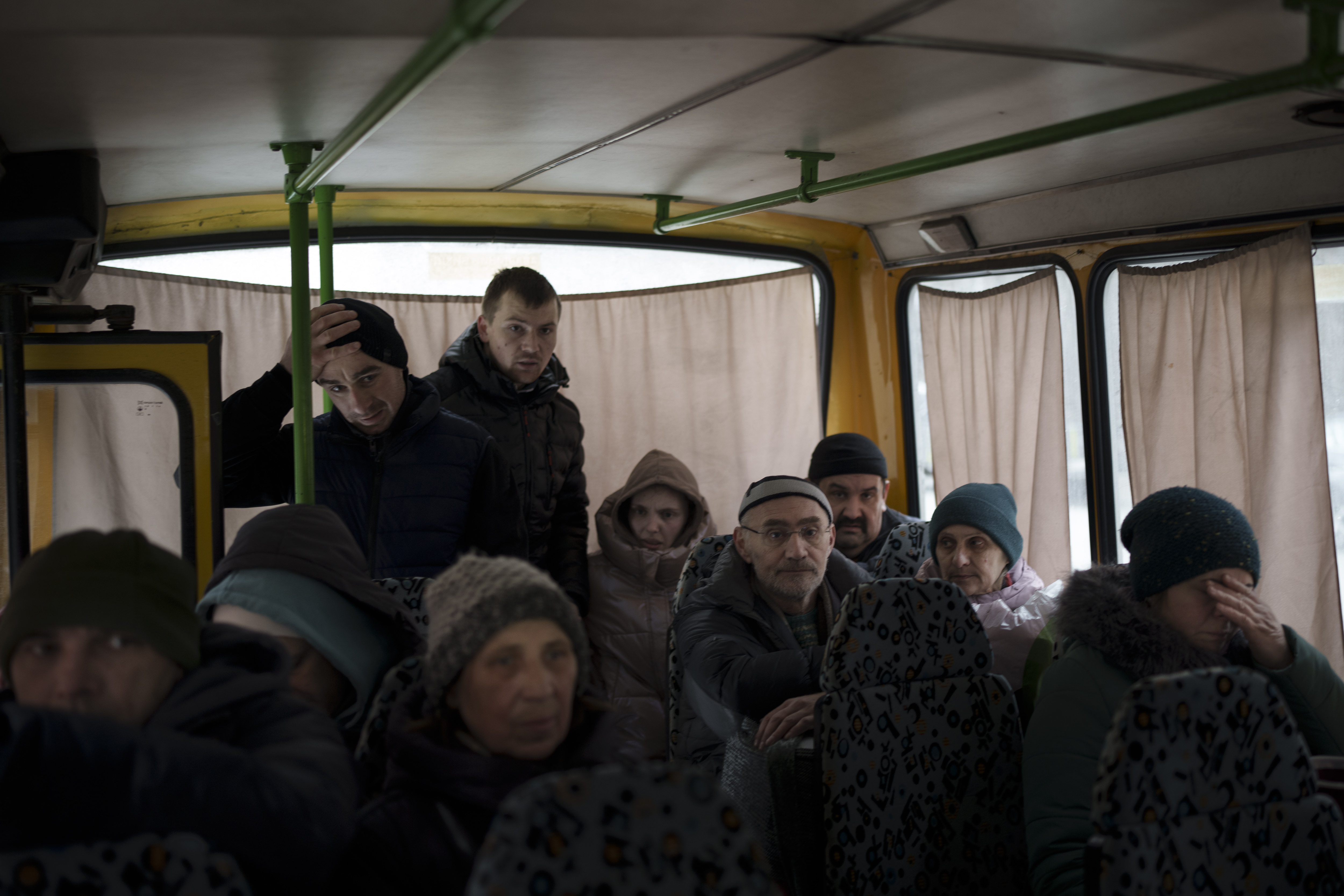 Ukrainians enter a bus as they are evacuated from Irpin, Ukraine, on March 9.