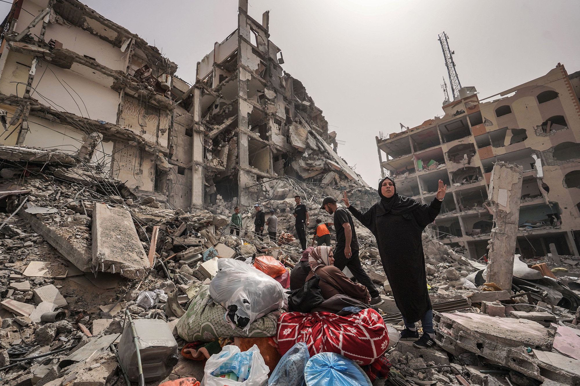 Palestinians inspect the damage to a building in the city of Nuseirat in central Gaza on April 18.
