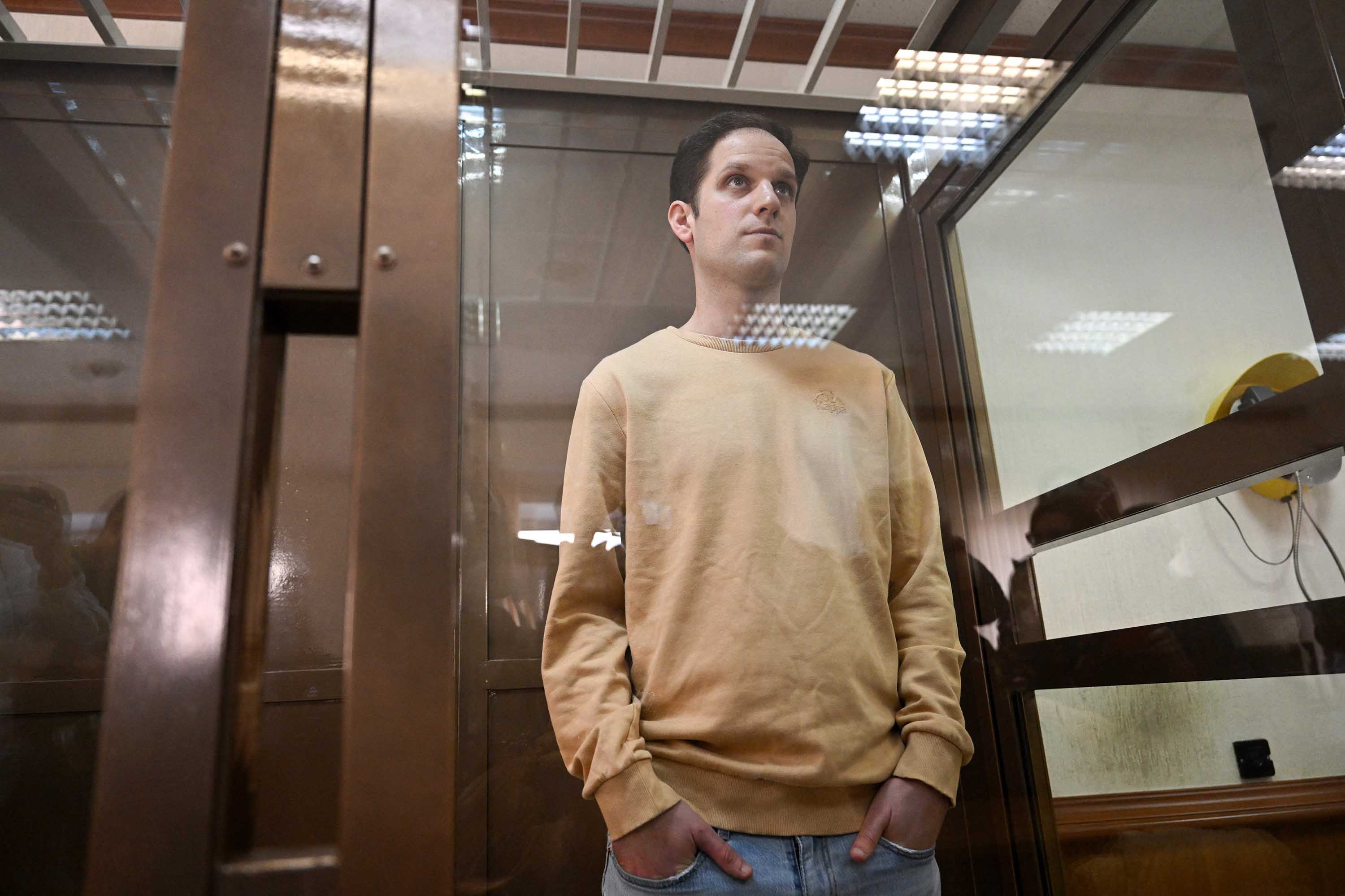 Evan Gershkovich stands inside a defendants' cage before a hearing at the Moscow City Court on Tuesday, September 19. 