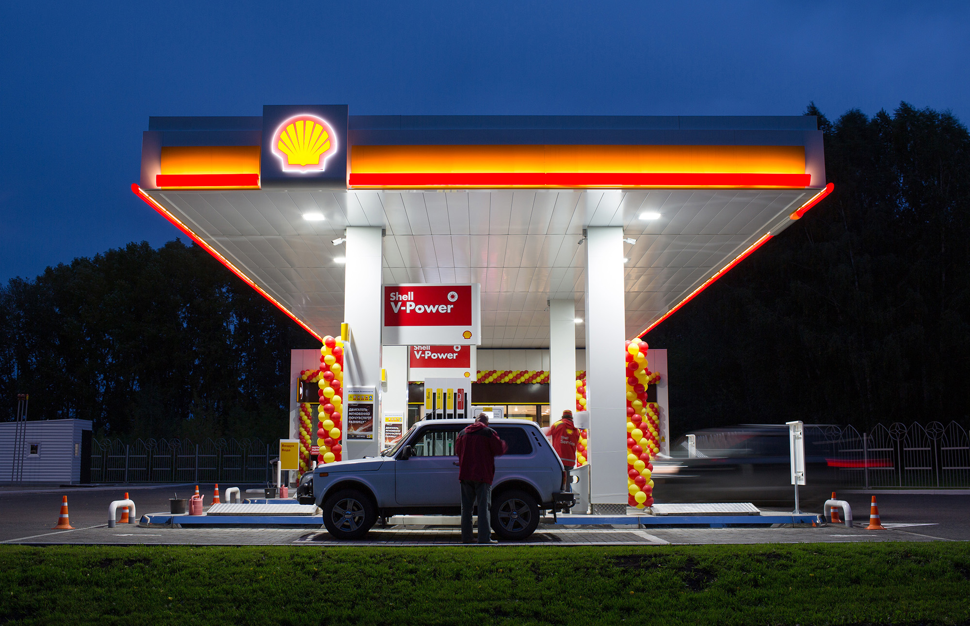 Attendants serve customers on the forecourt of a newly opened gas station, operated by Royal Dutch Shell Plc, in Kemerovo, Russia, on September 14, 2018.
