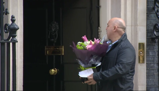 A delivery man brings flowers to the door of the Prime Minister's residence on Friday.