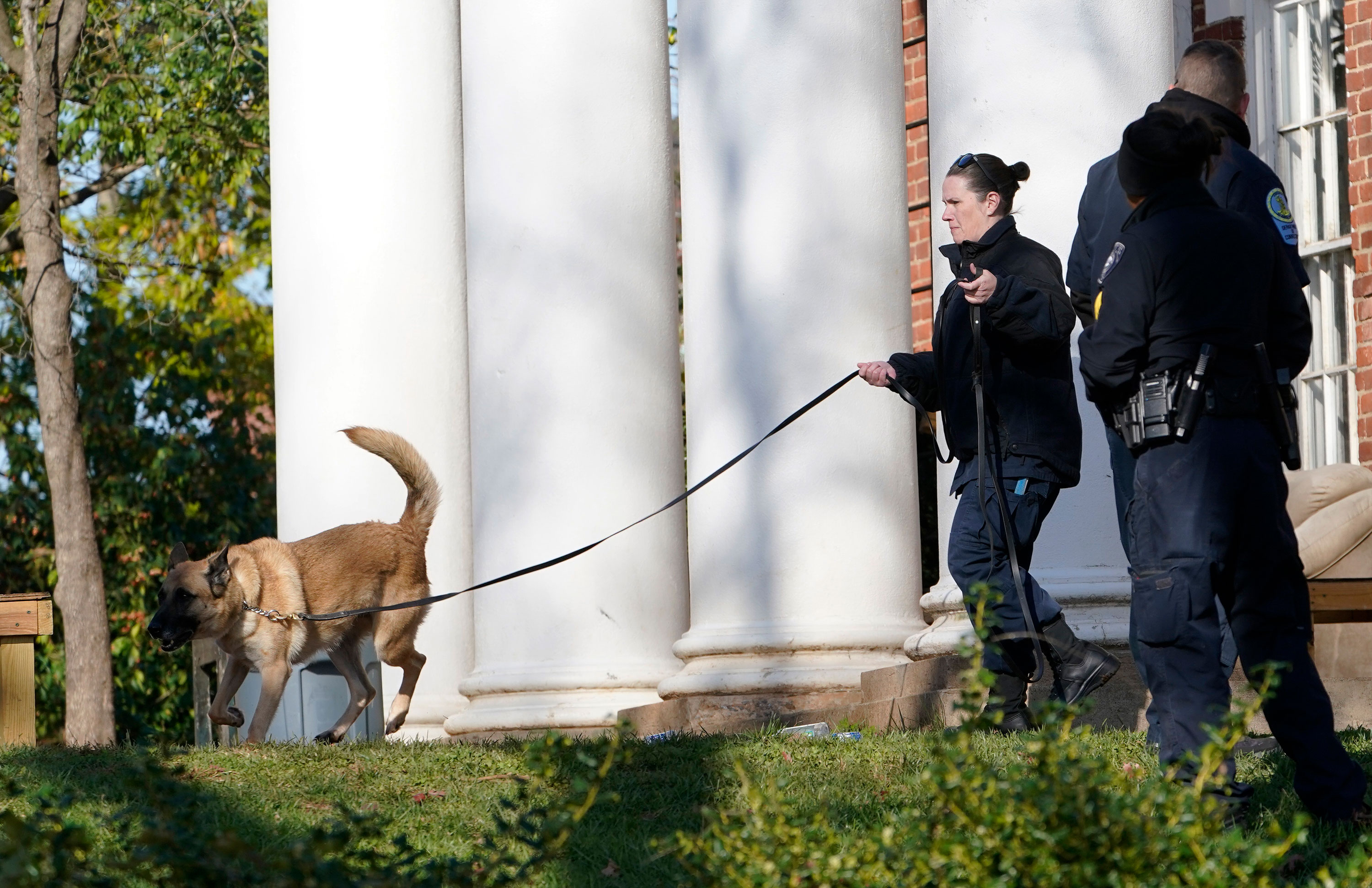 A Virginia Department of Corrections canine team searches the University of Virginia on Monday.